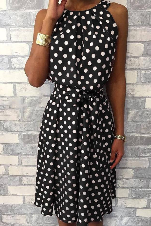 Black Midi dress with a playful polka dot print, featuring a round collar, sleeveless design, and decorative waist ribbon.