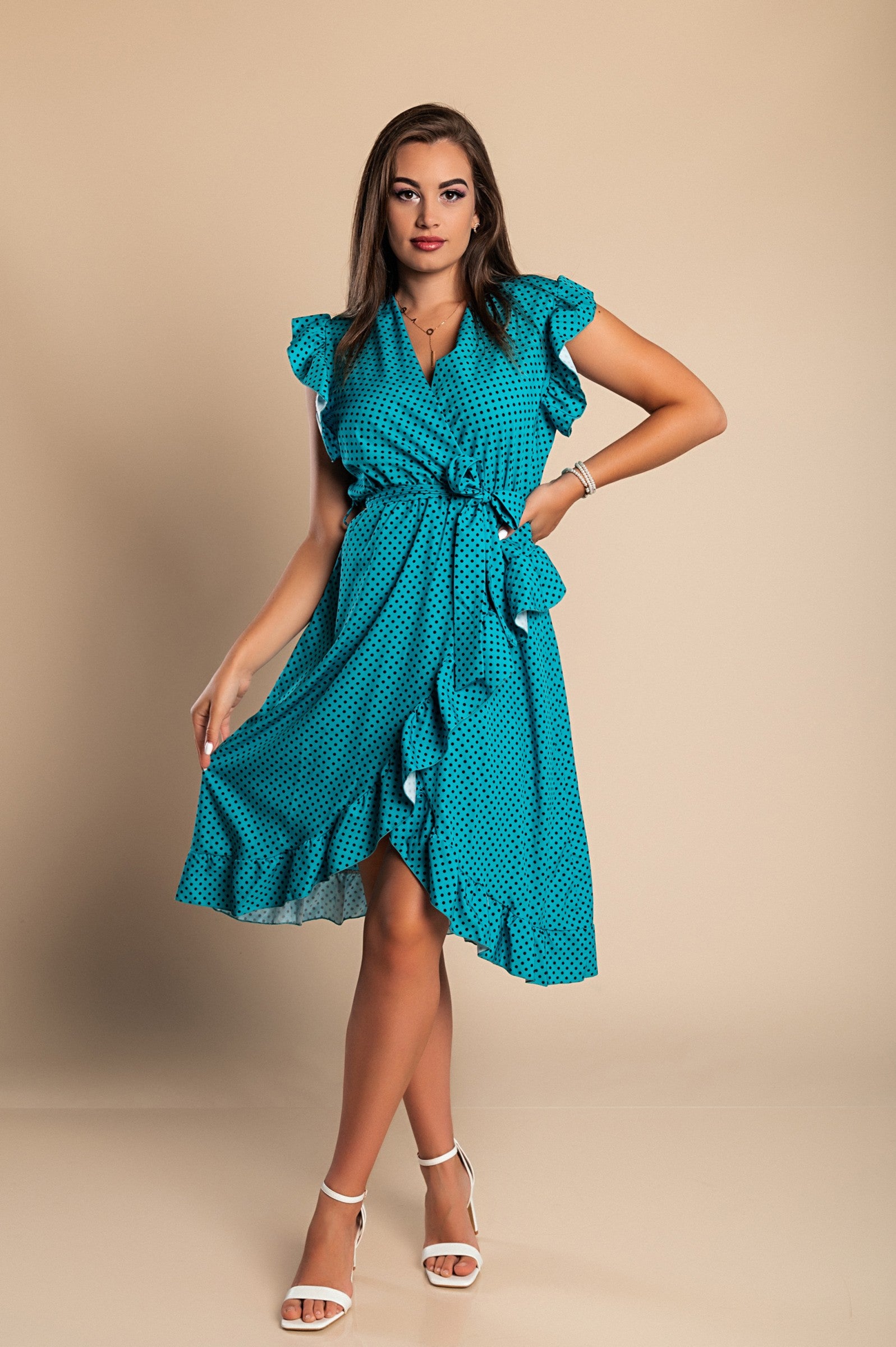 Mint midi dress with polka dot print featuring a V-neckline and ruffled sleeves, elegantly styled with a decorative belt.