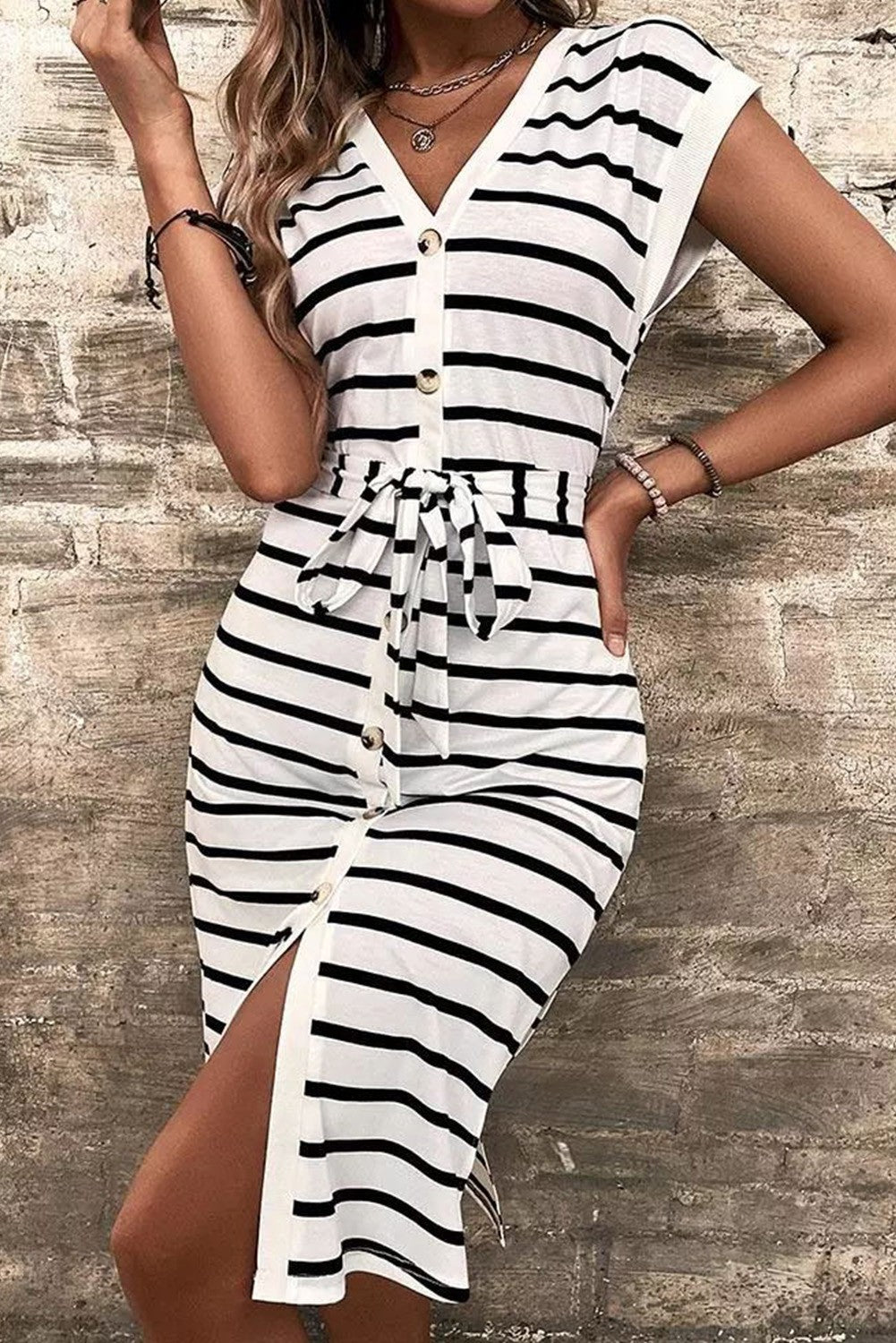 A stylish black and white striped midi dress featuring a deep V neckline, short sleeves, and buttons down the front, perfect for any occasion.