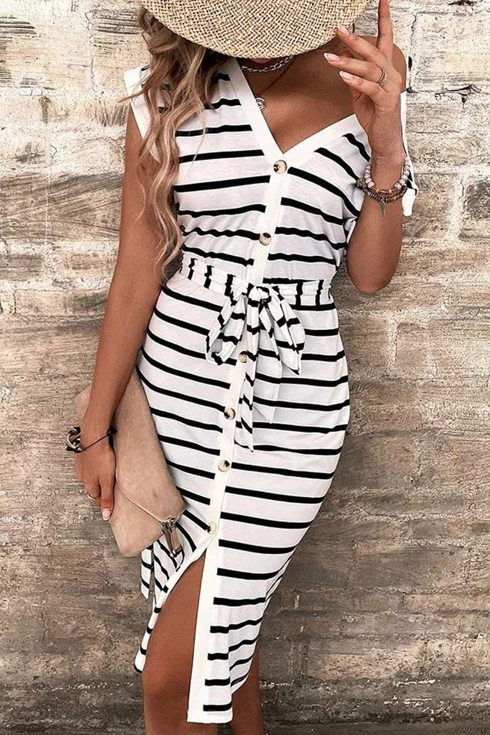 A stylish black and white striped midi dress featuring a deep V neckline, short sleeves, and buttons down the front, perfect for any occasion.