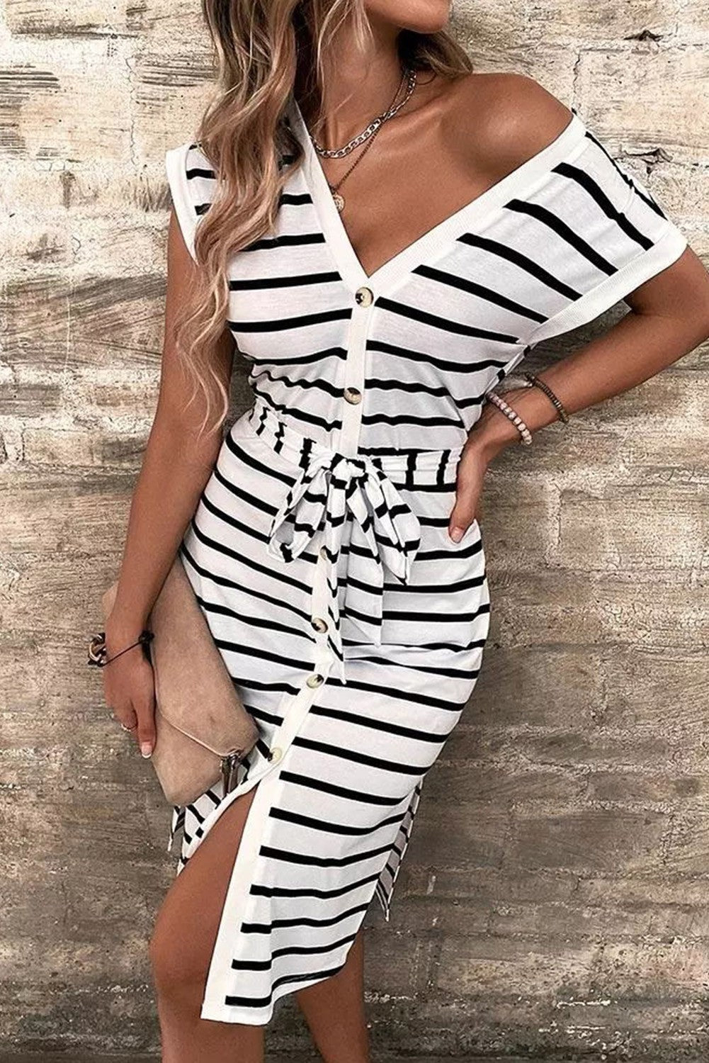 A stylish black and white striped midi dress featuring a deep V neckline, short sleeves, and front buttons, perfect for any occasion.