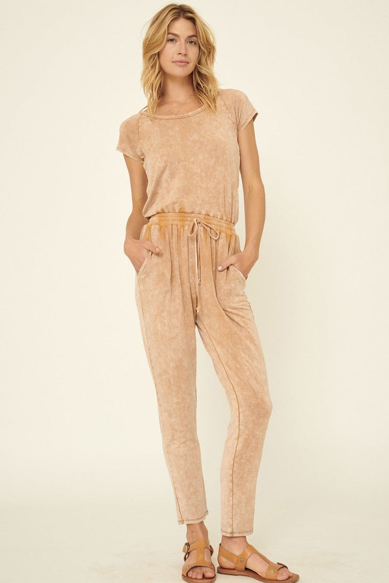 Mineral Washed Finish Knit Jumpsuit in sand color with scoop neckline and short sleeves, featuring a relaxed fit and drawstring waist.