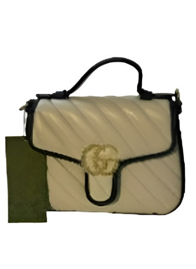 Mini GG Marmont chain shoulder bag in beige with black leather trim and gold-toned hardware, featuring a Double G logo.