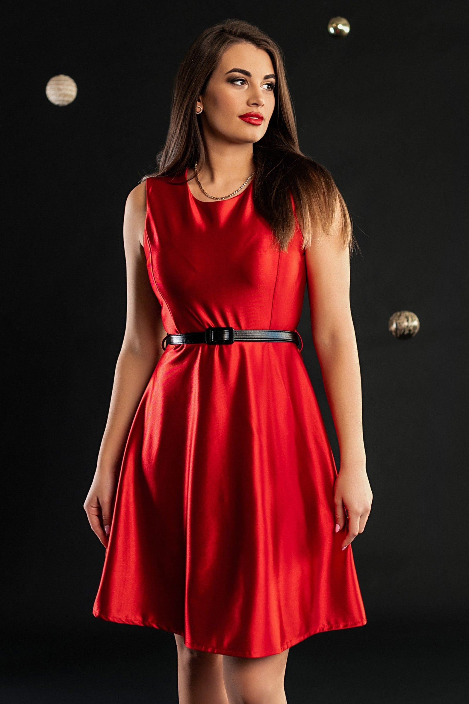 A stylish red mini dress made of imitation satin, featuring a round neckline, sleeveless design, and a decorative belt.
