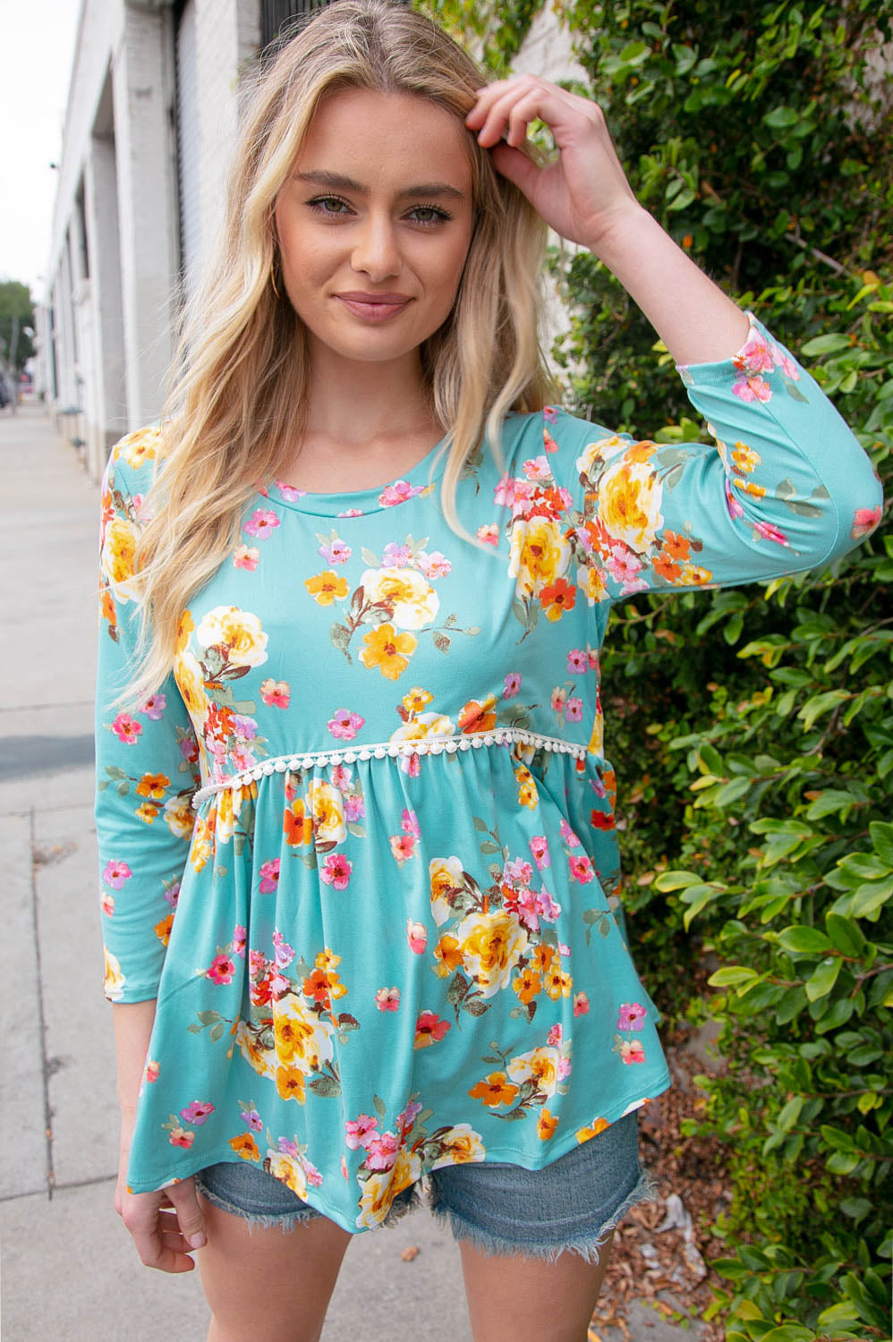 Mint three-quarter sleeve floral peplum babydoll top featuring dotted crochet lace and a classic crew neck.