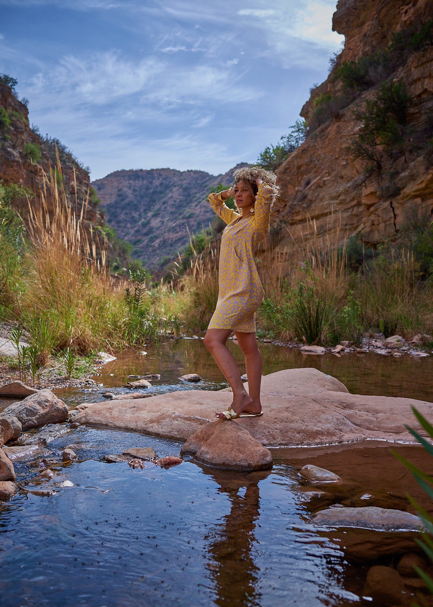 A vibrant yellow mixed print shirt dress featuring elegant patterns, perfect for summer outings.