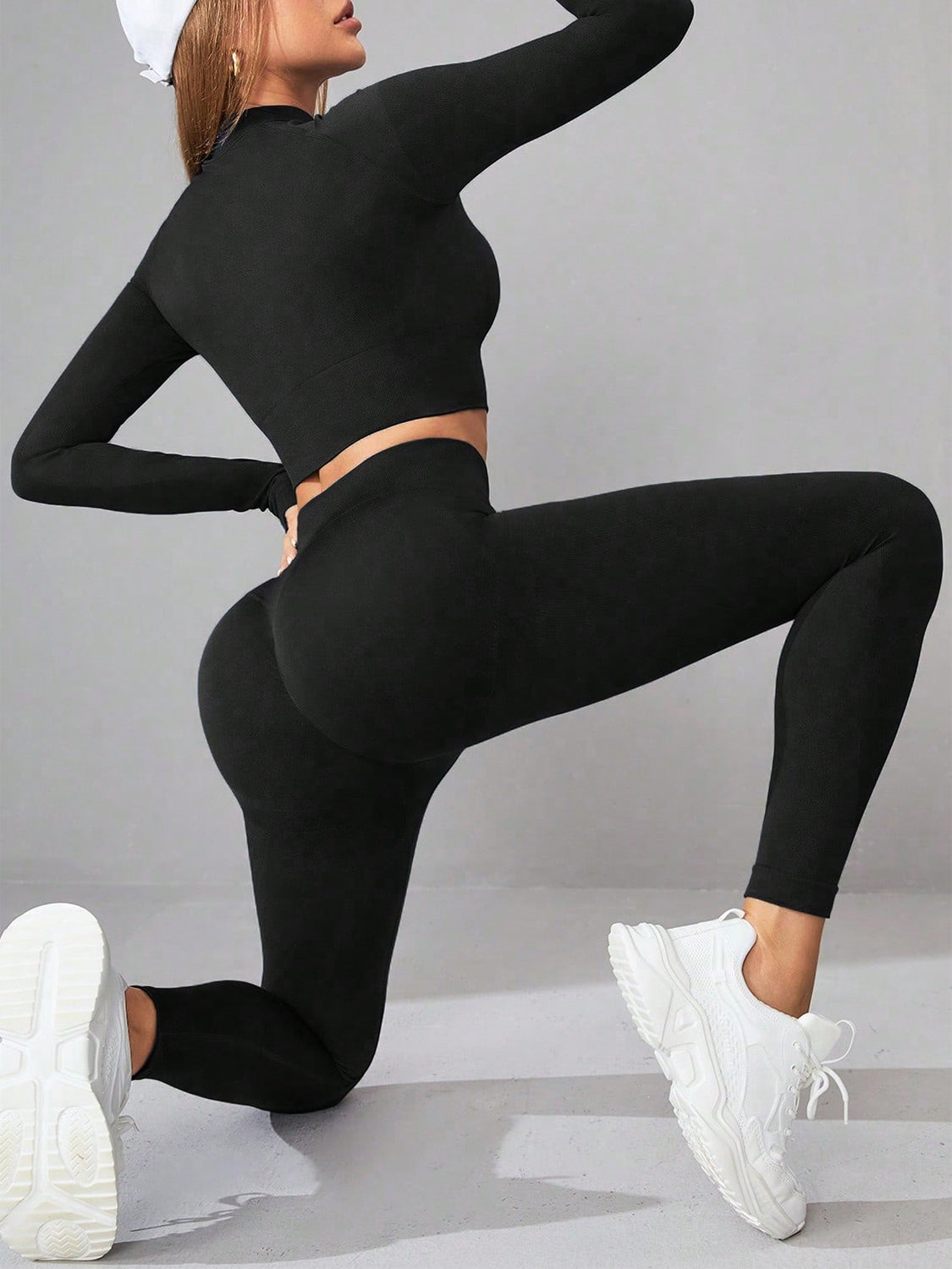Mock Neck Long Sleeve Top and Leggings Active Set displayed on a mannequin, showcasing the stylish design and stretchy fabric.