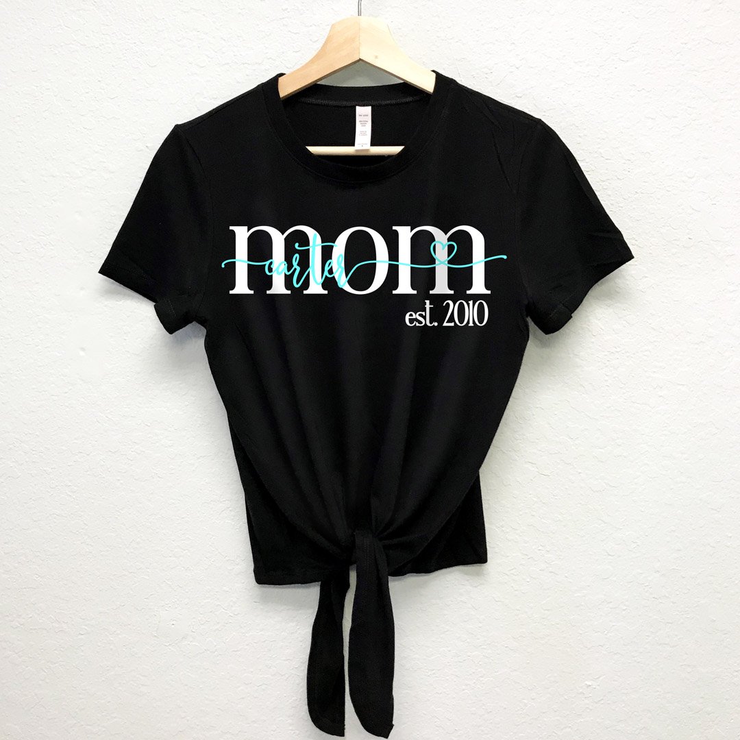 Black front tie crop top with 'MOM est. 2018' printed, customizable with names in pink or aqua colors.