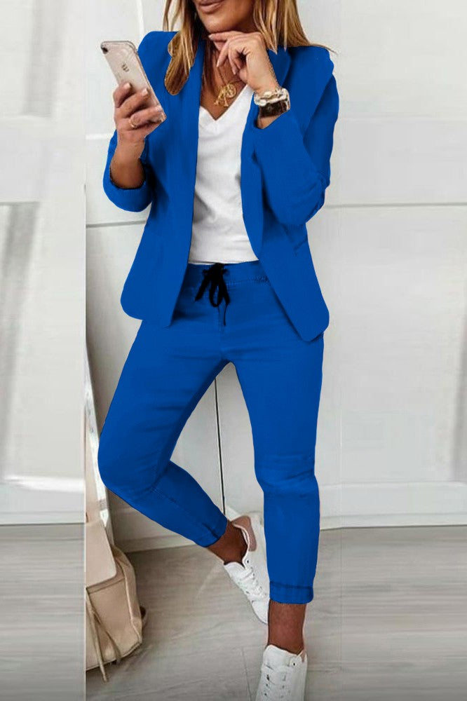Monochrome blue elegant trousers and blazer set, showcasing a stylish design with a classic collar and slim fit trousers.