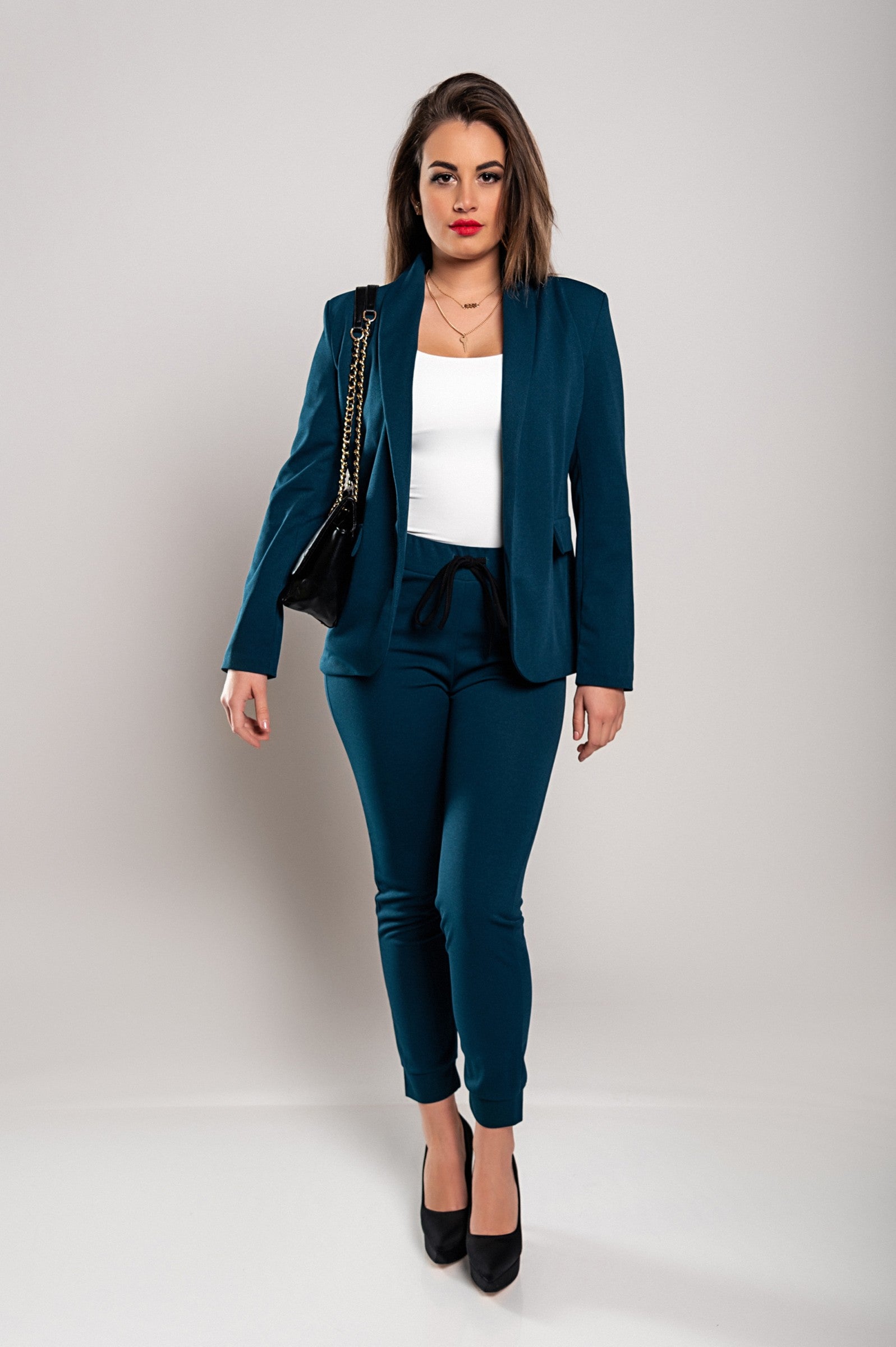 Monochrome elegant trousers and blazer set in petrol color, showcasing a stylish blazer with long sleeves and slim-fit trousers with a drawstring waist.