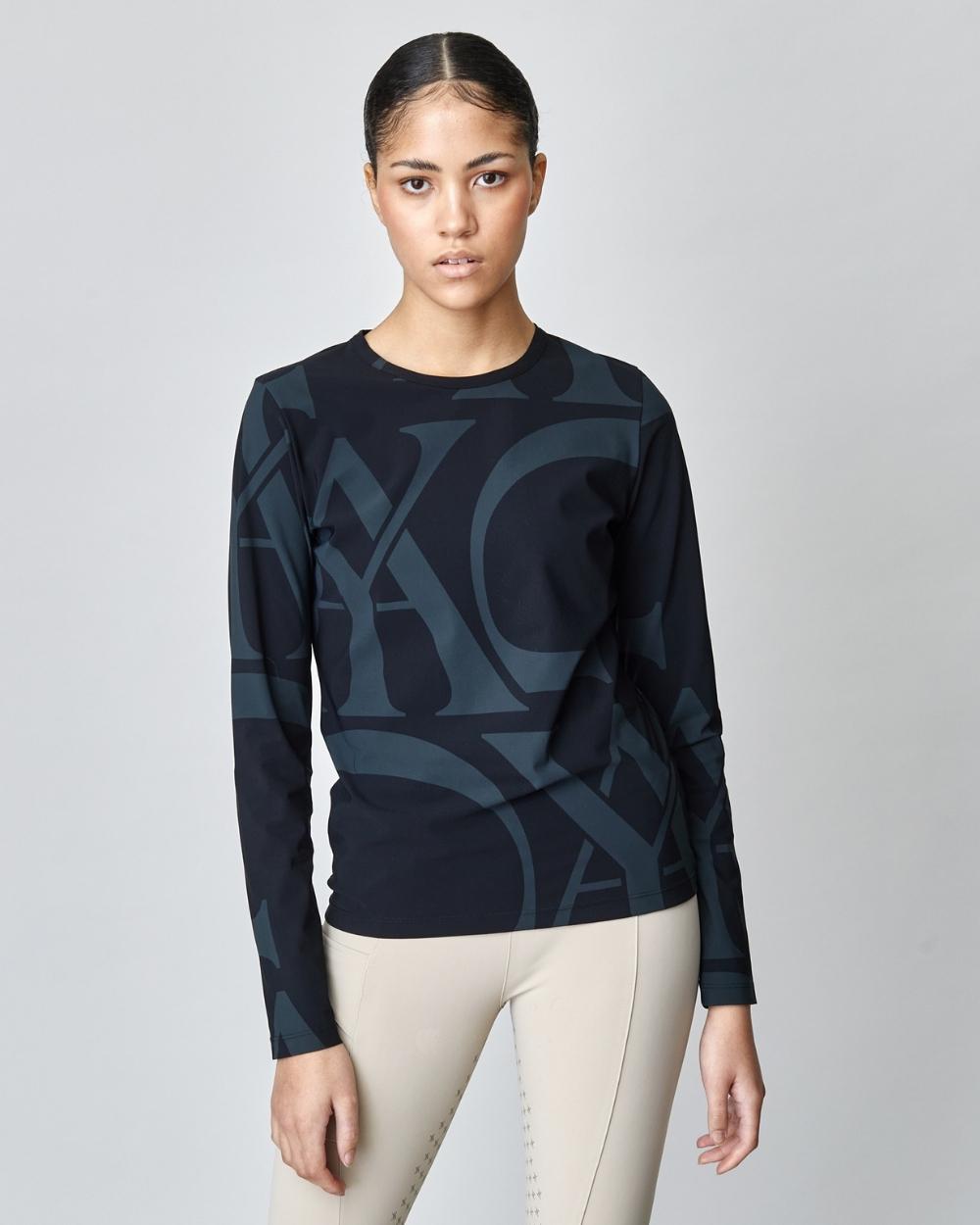 A fitted black long sleeve shirt featuring Yagya's signature monogram, made from breathable Italian jersey with UV protection.