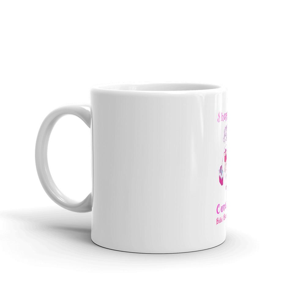 A glossy white ceramic mug with the phrase 'Because Shopping Cures Me' printed in vibrant colors, perfect for coffee or tea.