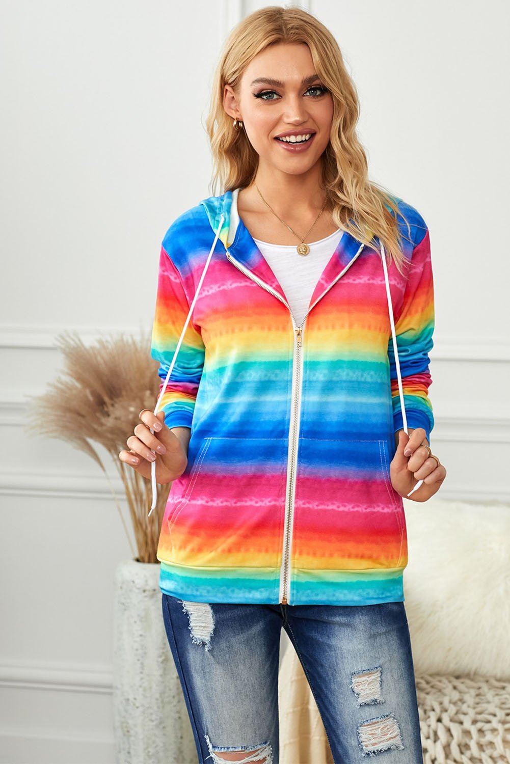 Multicolor tie-dyed hooded jacket with zipper pockets, showcasing vibrant colors and stylish design.