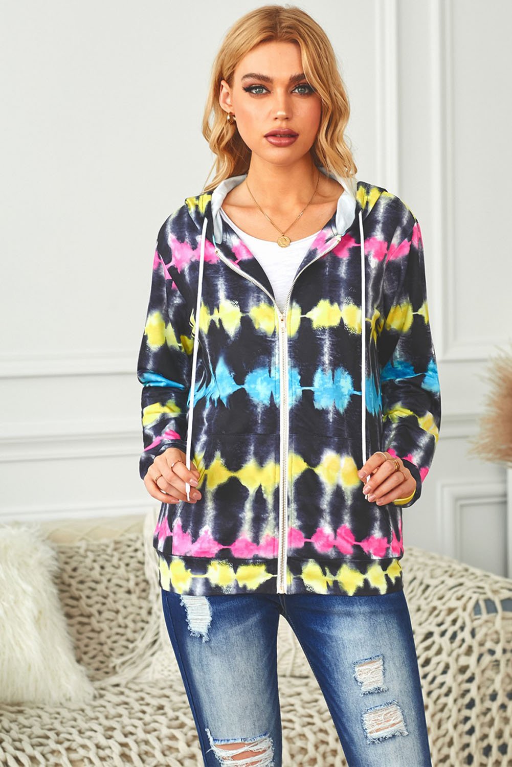 Multicolor tie-dyed hooded jacket with zipper pockets, showcasing vibrant colors and stylish design.
