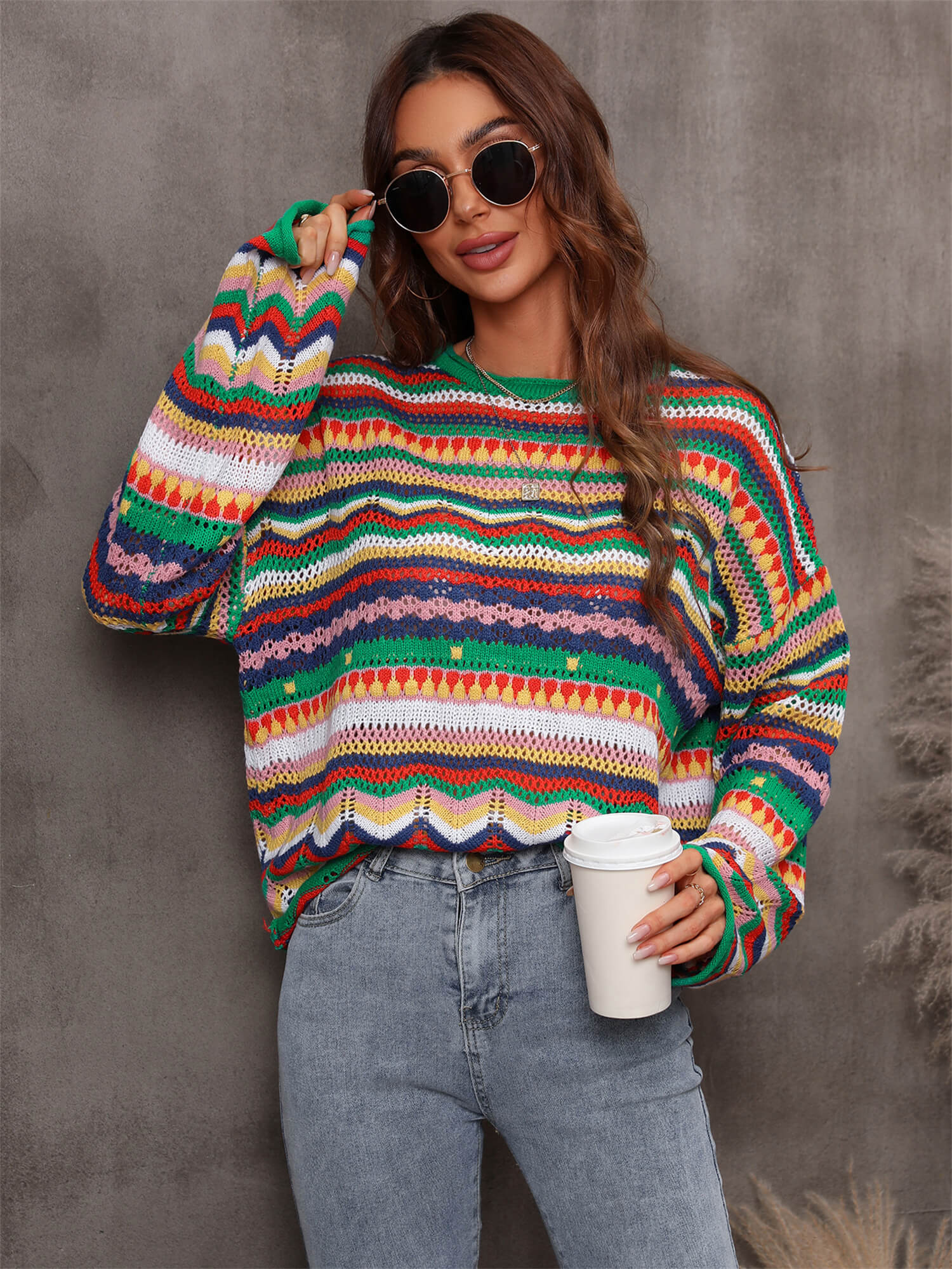 A stylish multicolored stripe openwork knit top featuring a round neck and long sleeves with dropped shoulders, made from soft acrylic material.