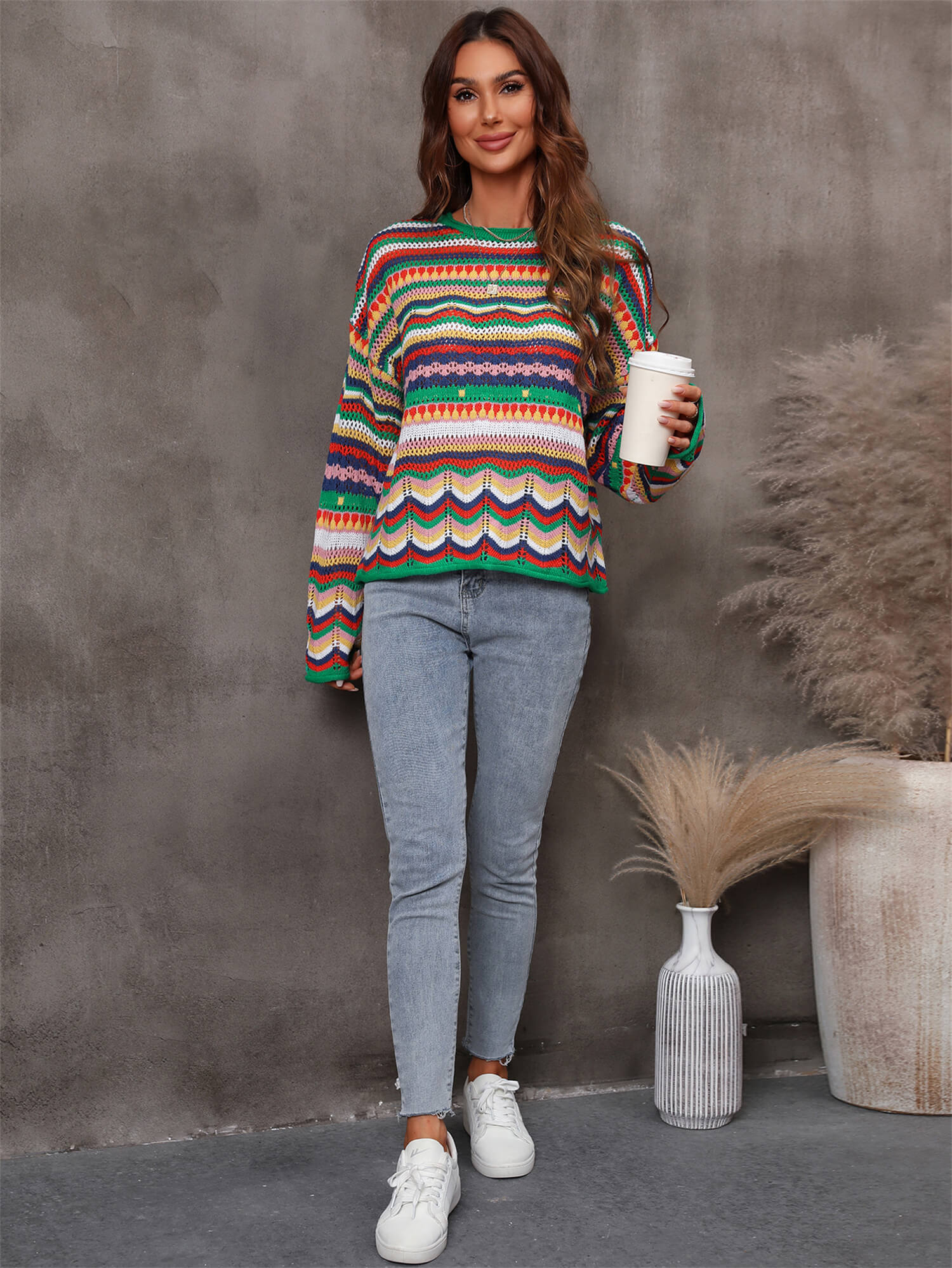 A stylish multicolored stripe openwork knit top featuring a round neck and long sleeves with dropped shoulders, made from soft acrylic material.