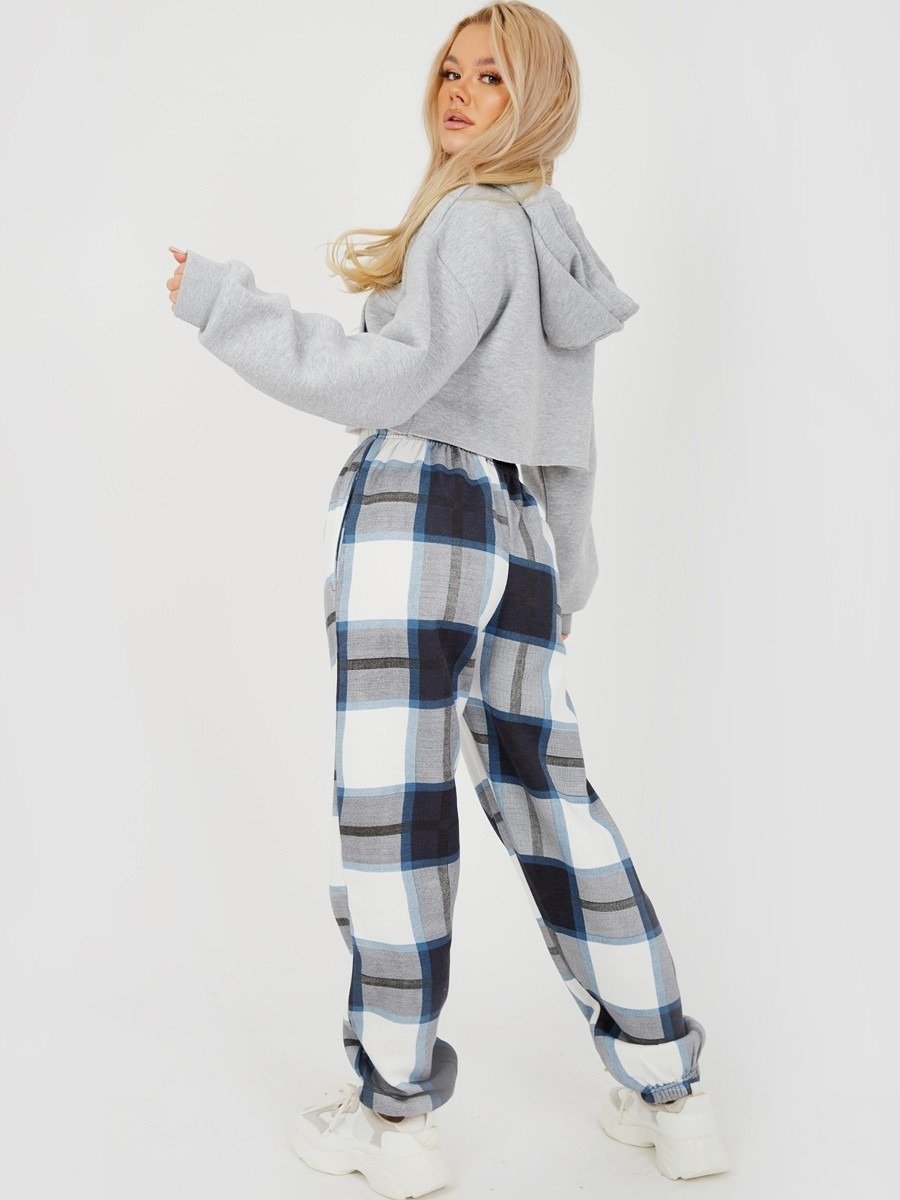 A pair of navy checked joggers for women featuring a light pink check print, high elasticated waist, and side pockets.