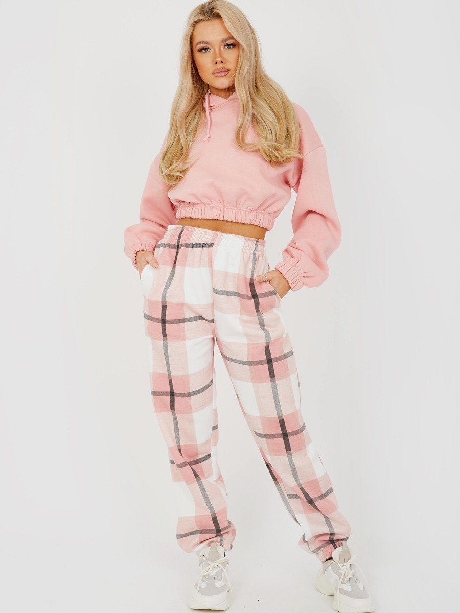 A pair of navy checked joggers for women featuring a light pink check print, high elasticated waist, and side pockets.