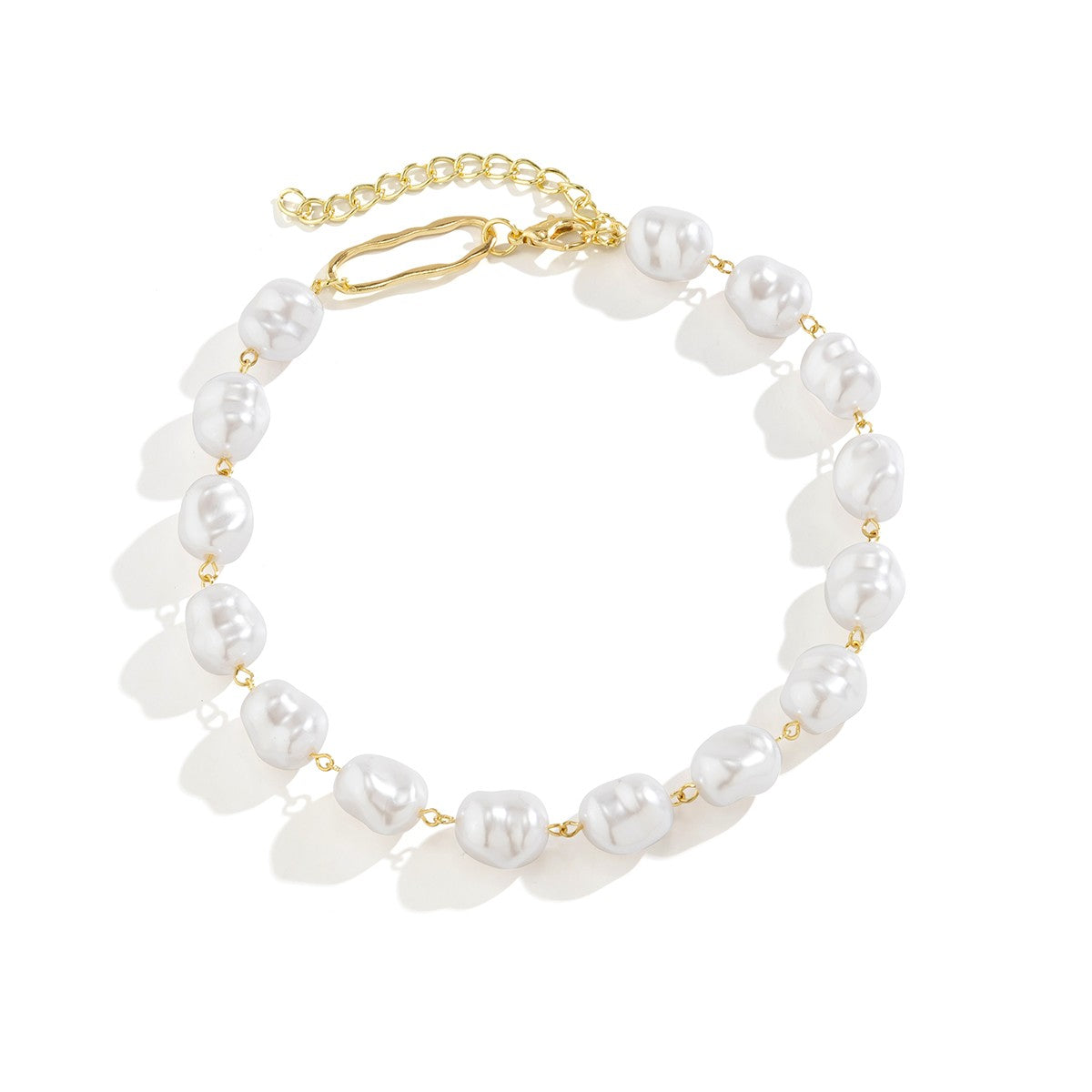 Elegant gold-colored necklace featuring oval-shaped imitation pearls, secured with a metal lobster clasp.