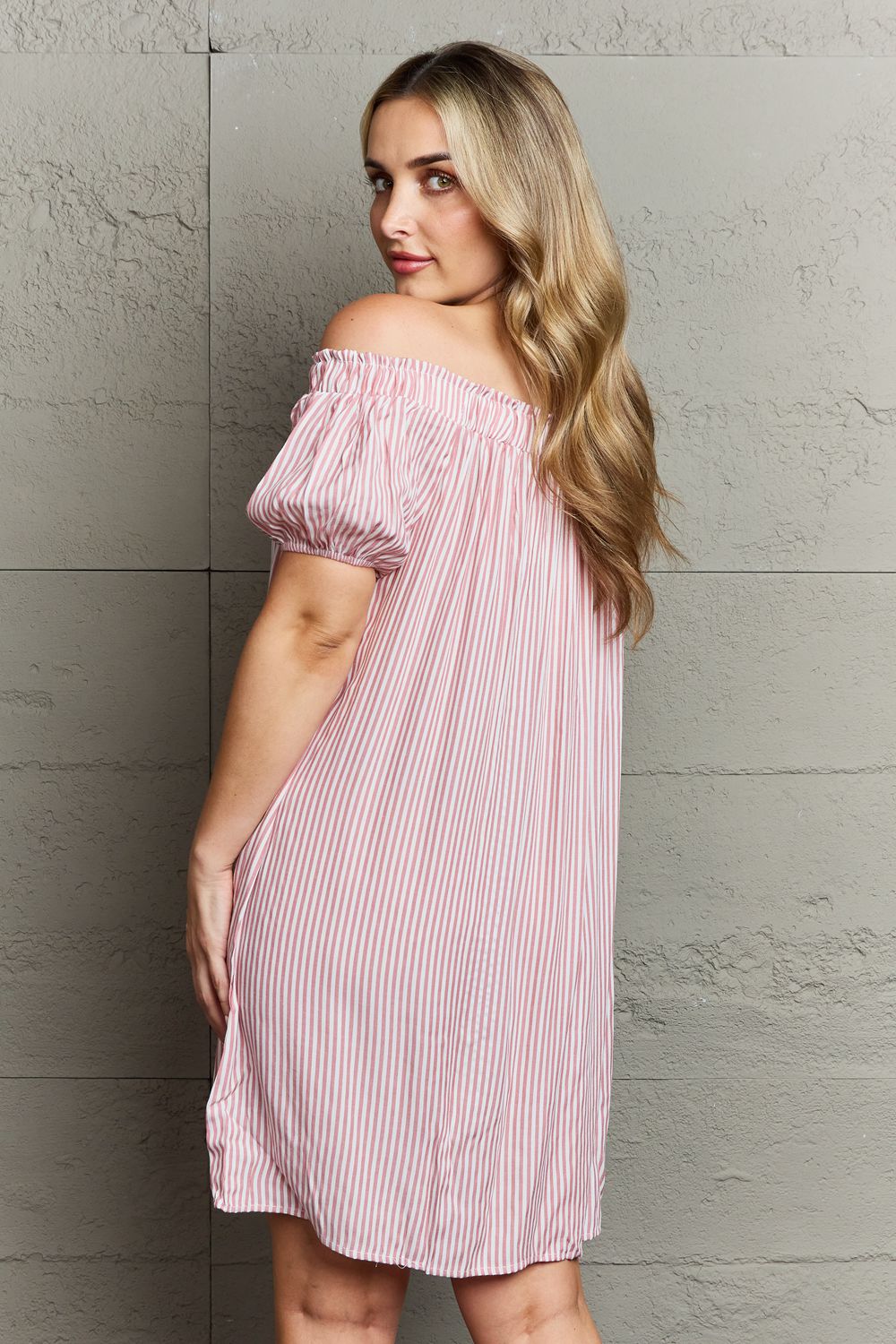 Ninexis Show Compassion Off The Shoulder Mini Dress featuring a chic striped pattern and decorative buttons, elegantly showcasing the shoulders.