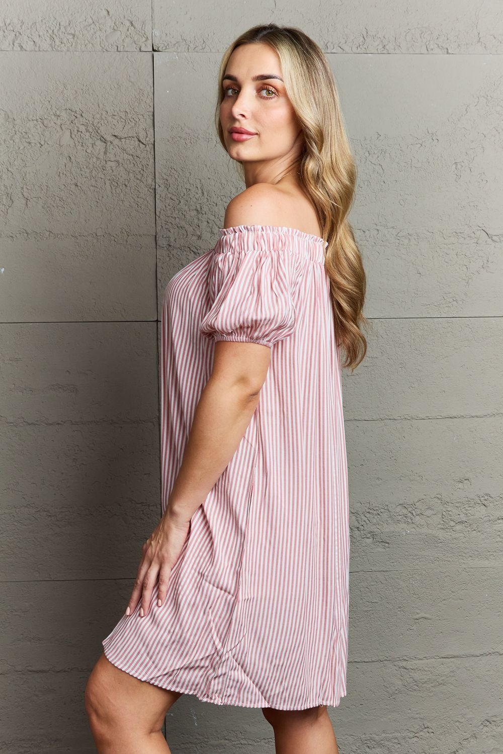 Ninexis Show Compassion Off The Shoulder Mini Dress featuring a chic striped pattern and decorative buttons, elegantly showcasing the shoulders.