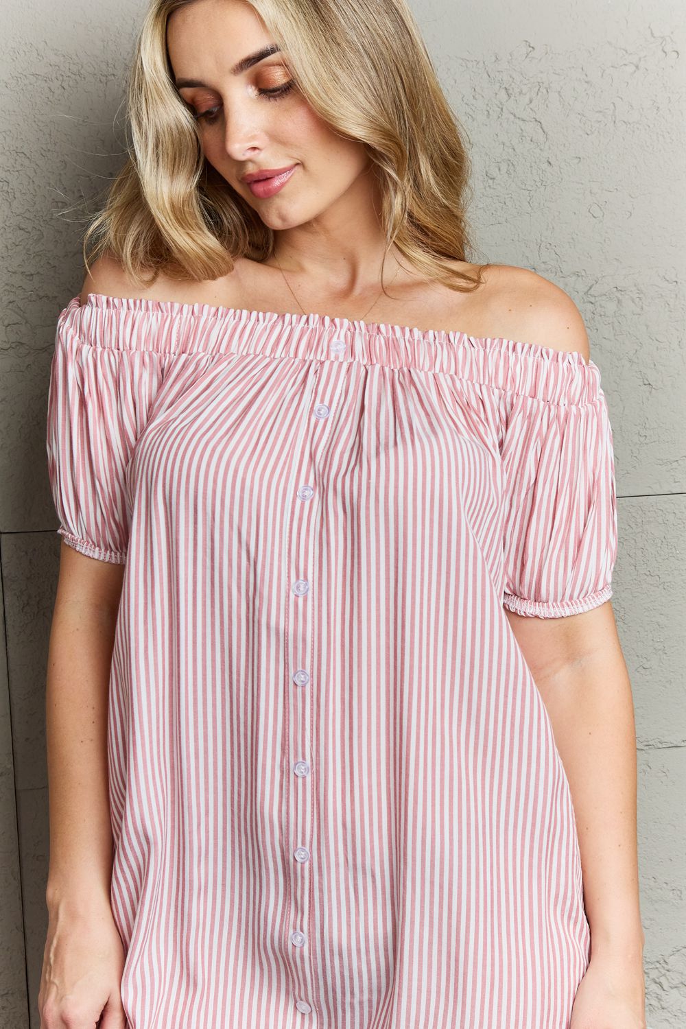 Ninexis Show Compassion Off The Shoulder Mini Dress featuring a chic striped pattern and decorative buttons, elegantly showcasing the shoulders.