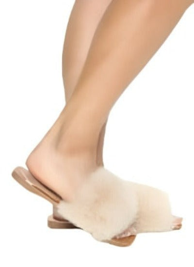 A pair of nude square toe slide sandals with a faux fur upper, showcasing a stylish and comfortable design.
