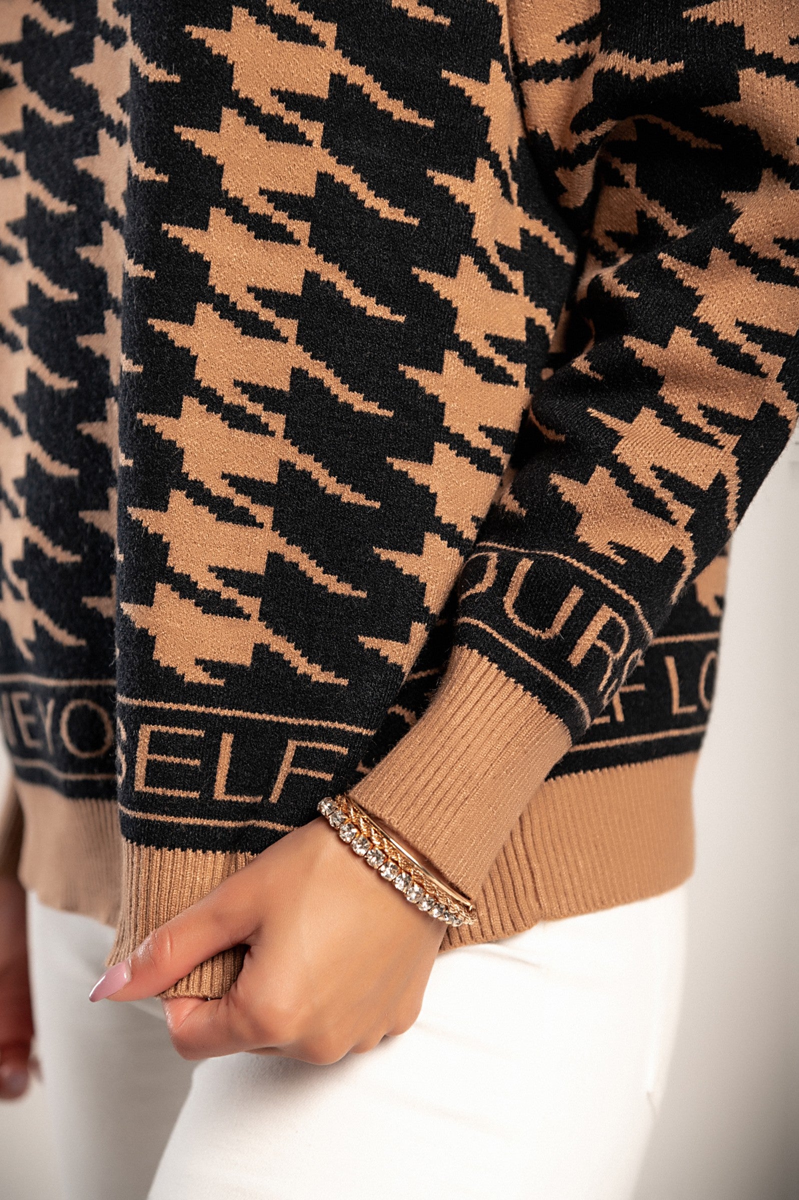 Brown-black nugget print jumper Sanga with long sleeves and high neck, showcasing its soft fabric and stylish design.