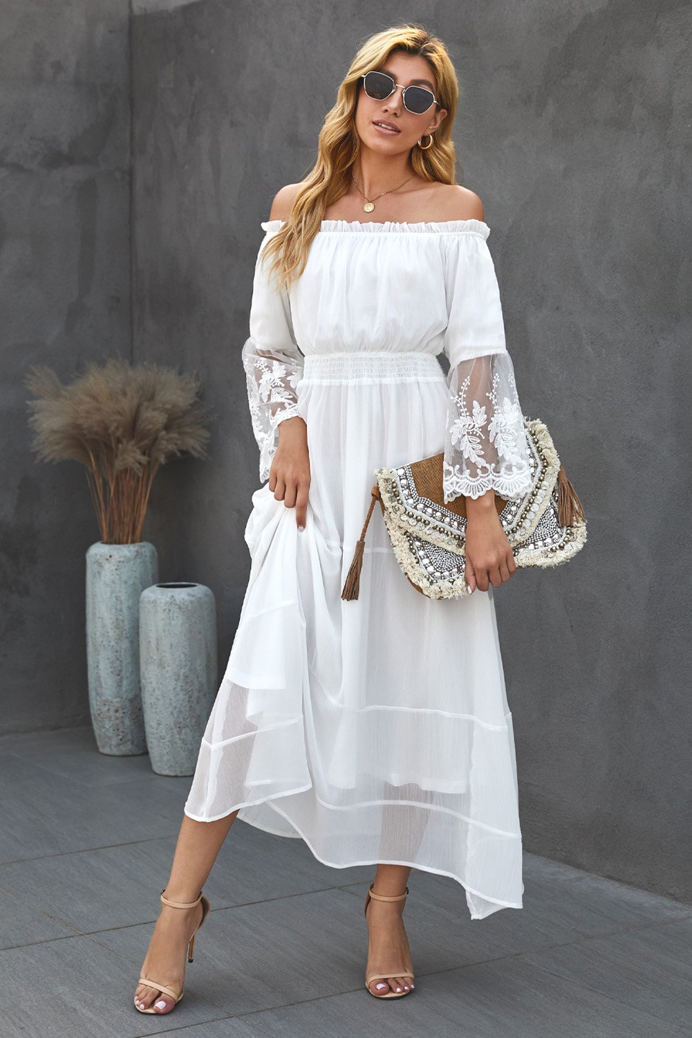A beautiful off-shoulder embroidered flared sleeve lace maxi dress, showcasing intricate embroidery and a flowing silhouette, perfect for various occasions.