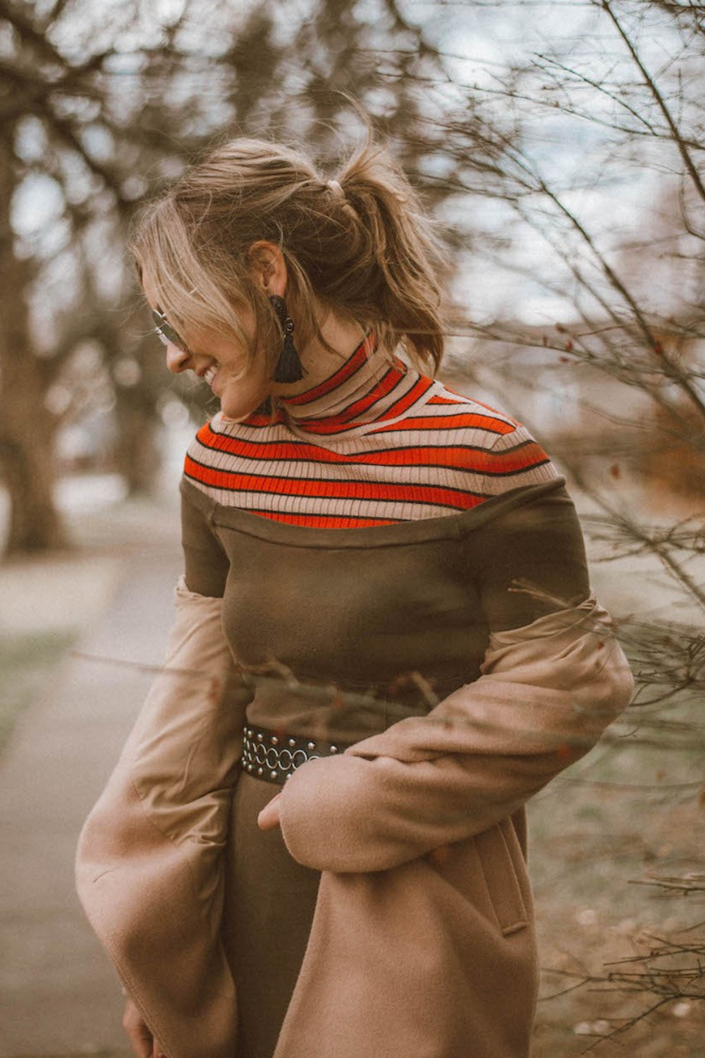 A stylish off the shoulder dress in brown, featuring long sleeves and a midi length, perfect for various occasions.