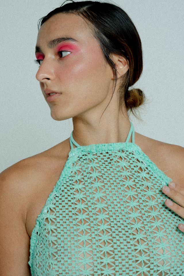 Open back cotton crochet dress in mint green with dark grey chiffon hem, showcasing a body-hugging design and adjustable strings.