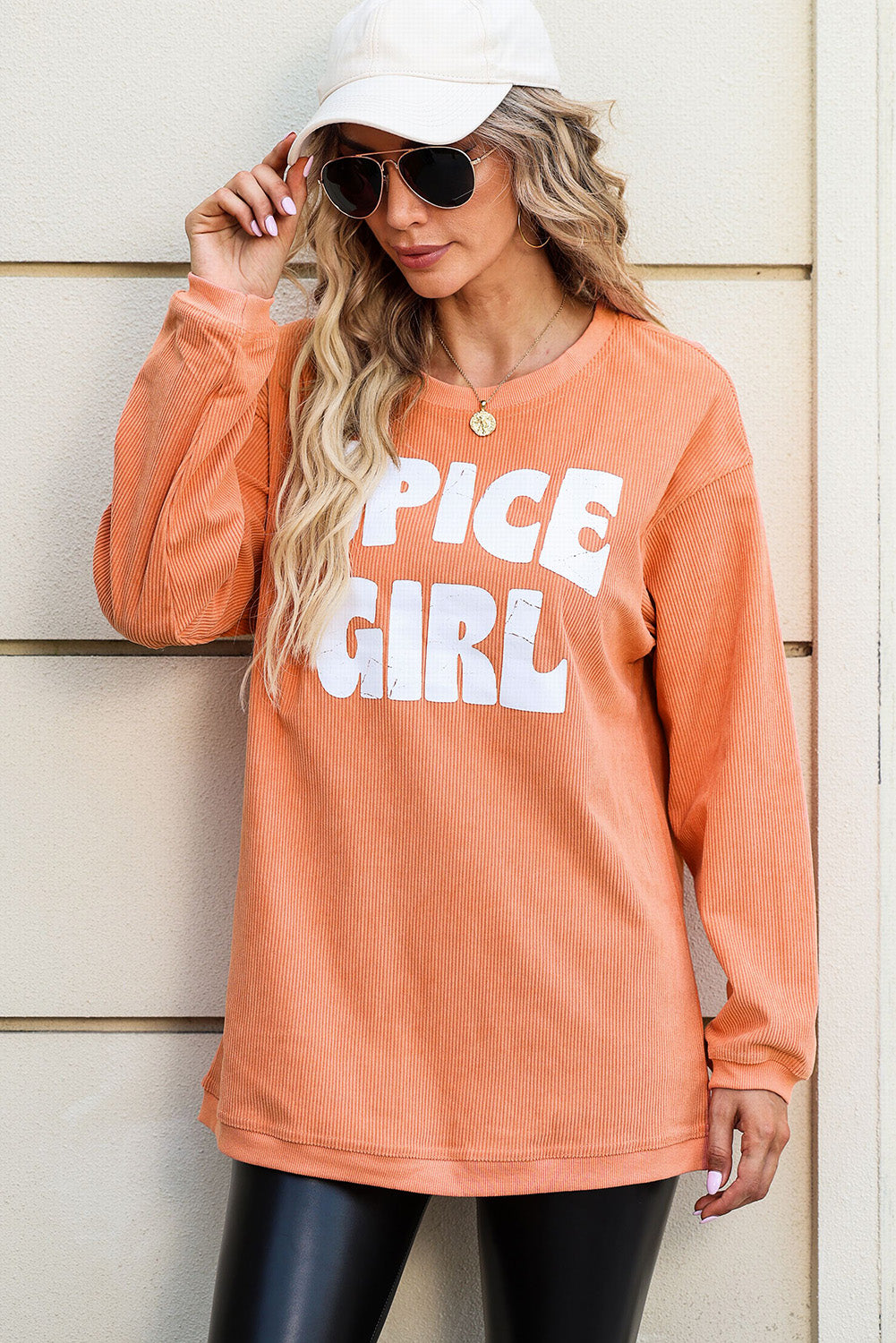 Orange corded sweatshirt featuring a sassy spice girl graphic design, perfect for casual wear and lounging.