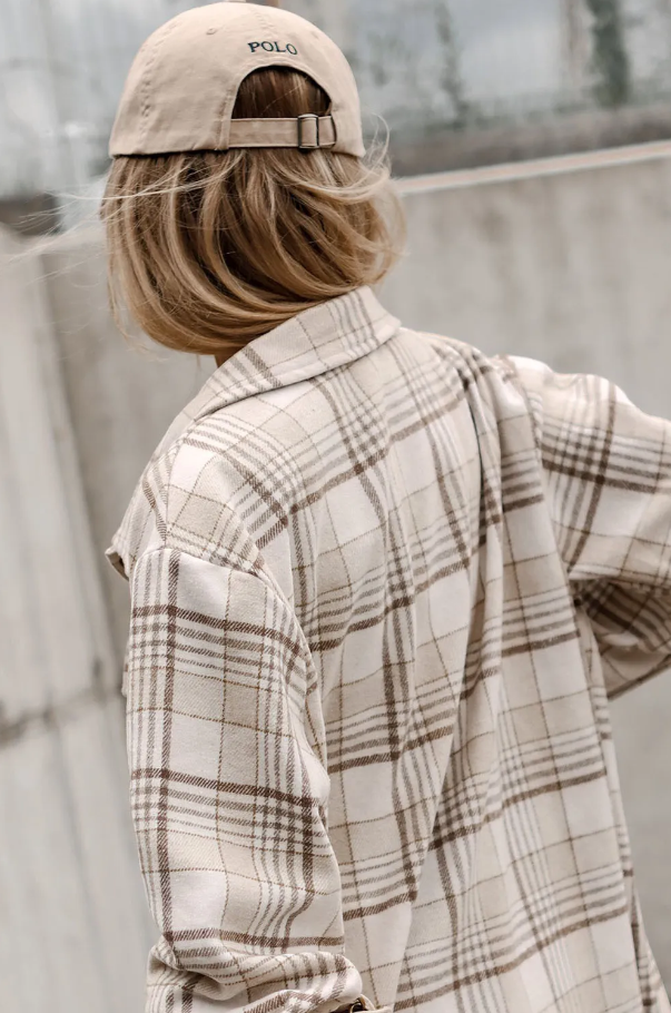 Khaki check print overshirt featuring a removable hood, long sleeves, and button closure, made from 100% polyester.
