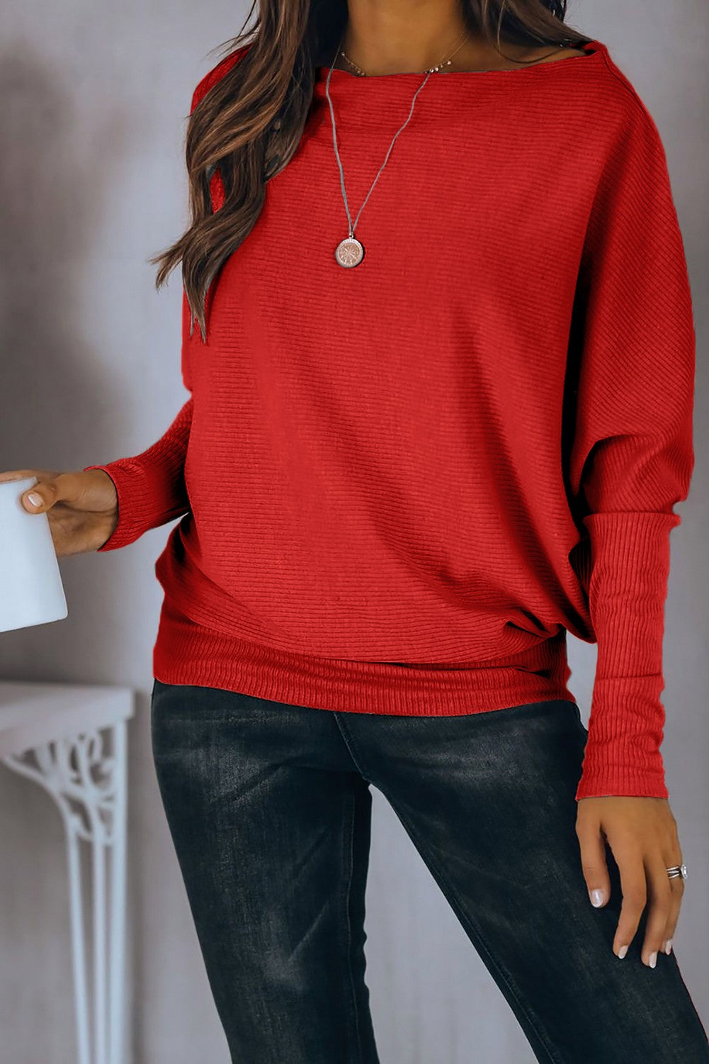 Red oversize T-shirt with boat neckline and loose sleeves, showcasing a relaxed fit and stylish design.