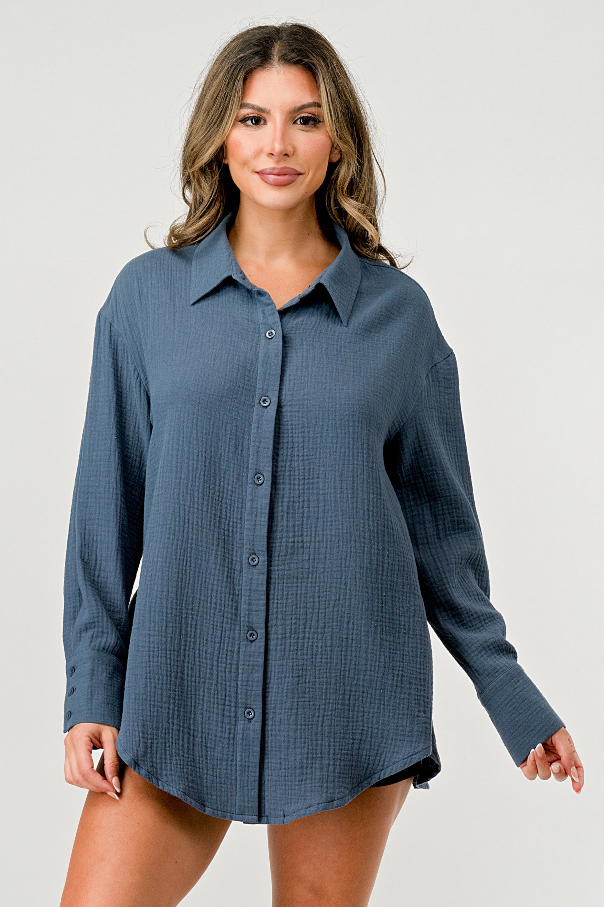 A stylish oversized button-up shirt made from soft solid gauze, featuring a button front and a slit back design for added breathability.