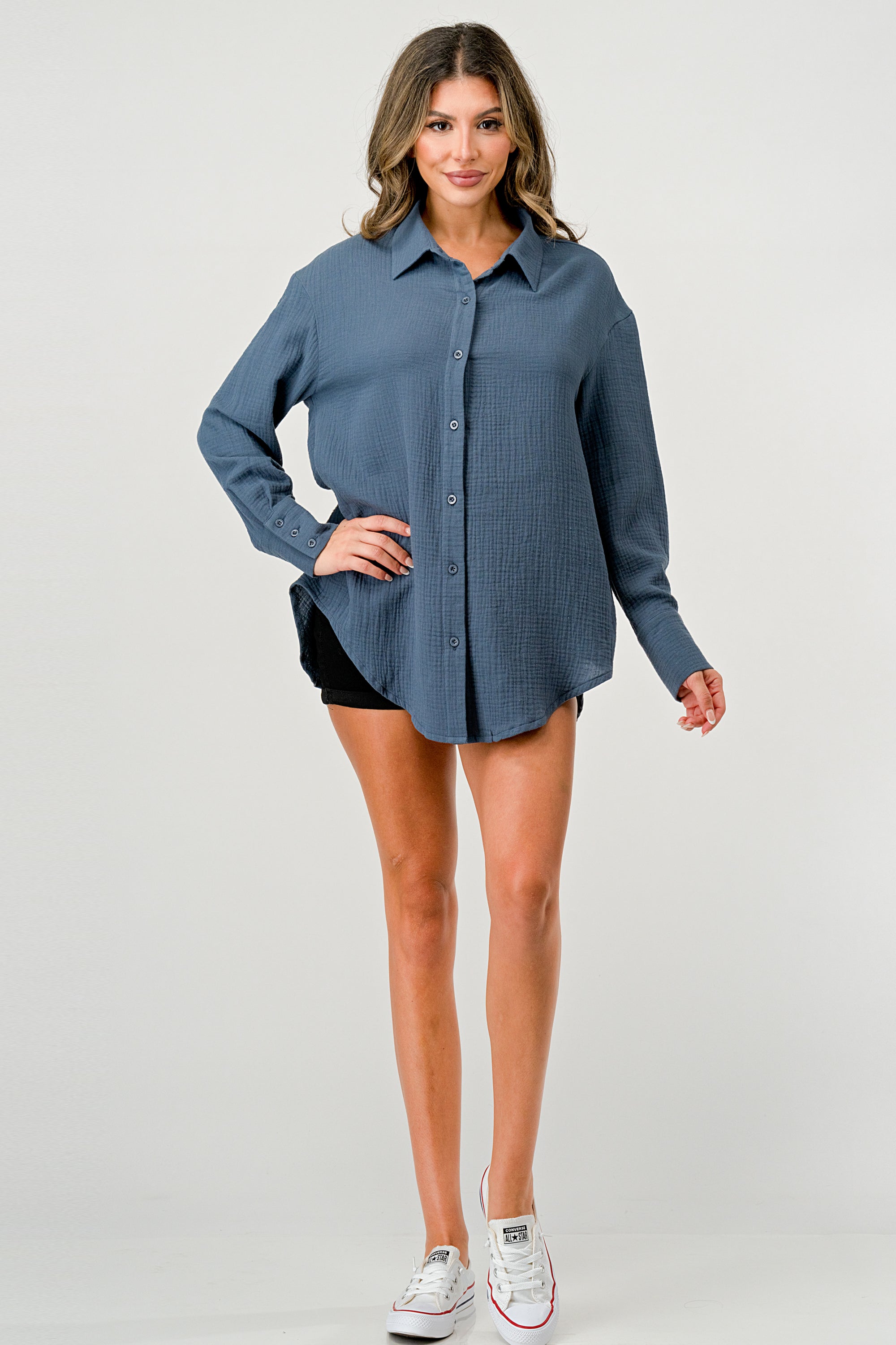 A stylish oversized button-up shirt made from soft solid gauze, featuring a button front and a slit back design for added breathability.