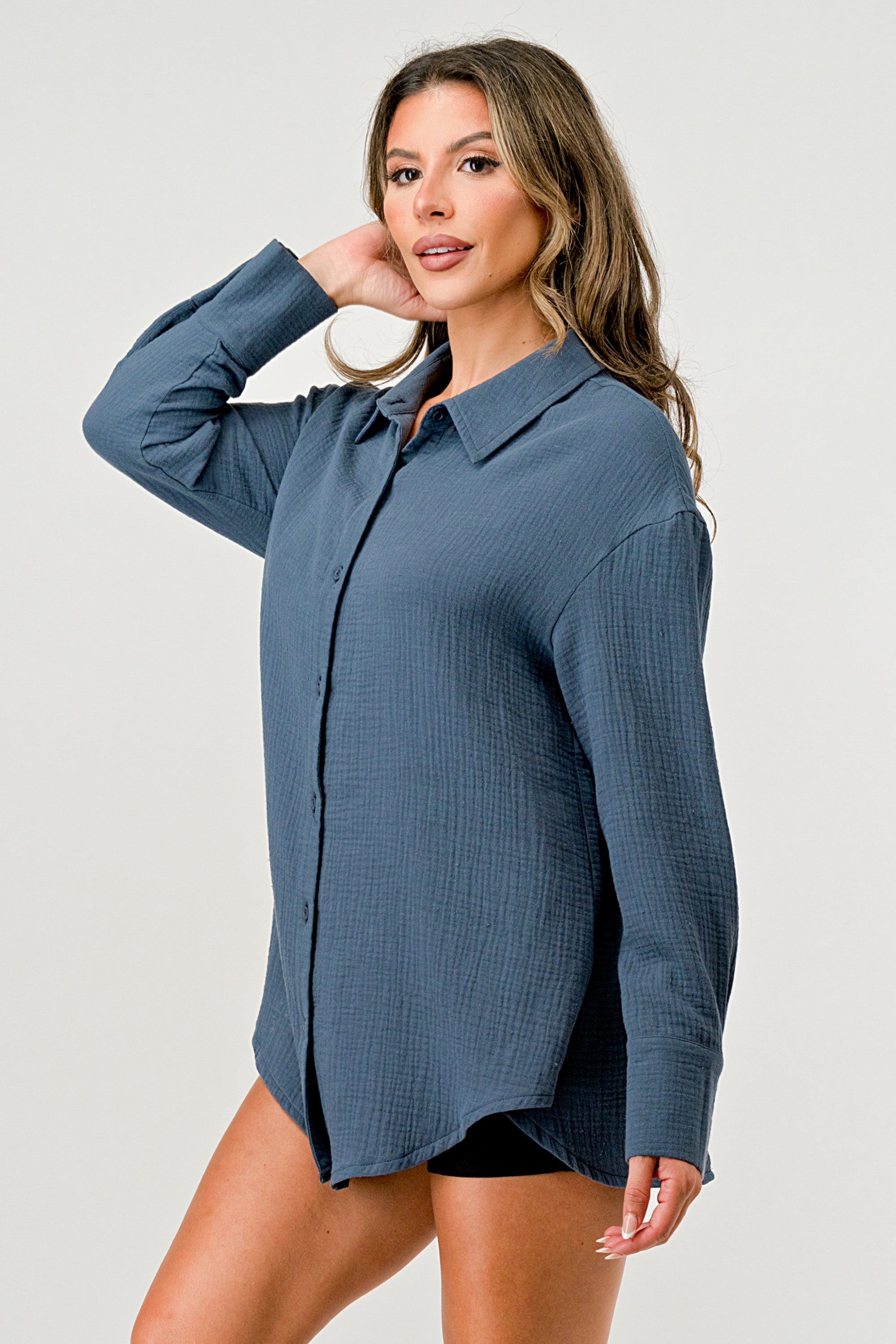 A stylish oversized button-up shirt made from soft solid gauze, featuring a button front and a slit back design for added breathability.