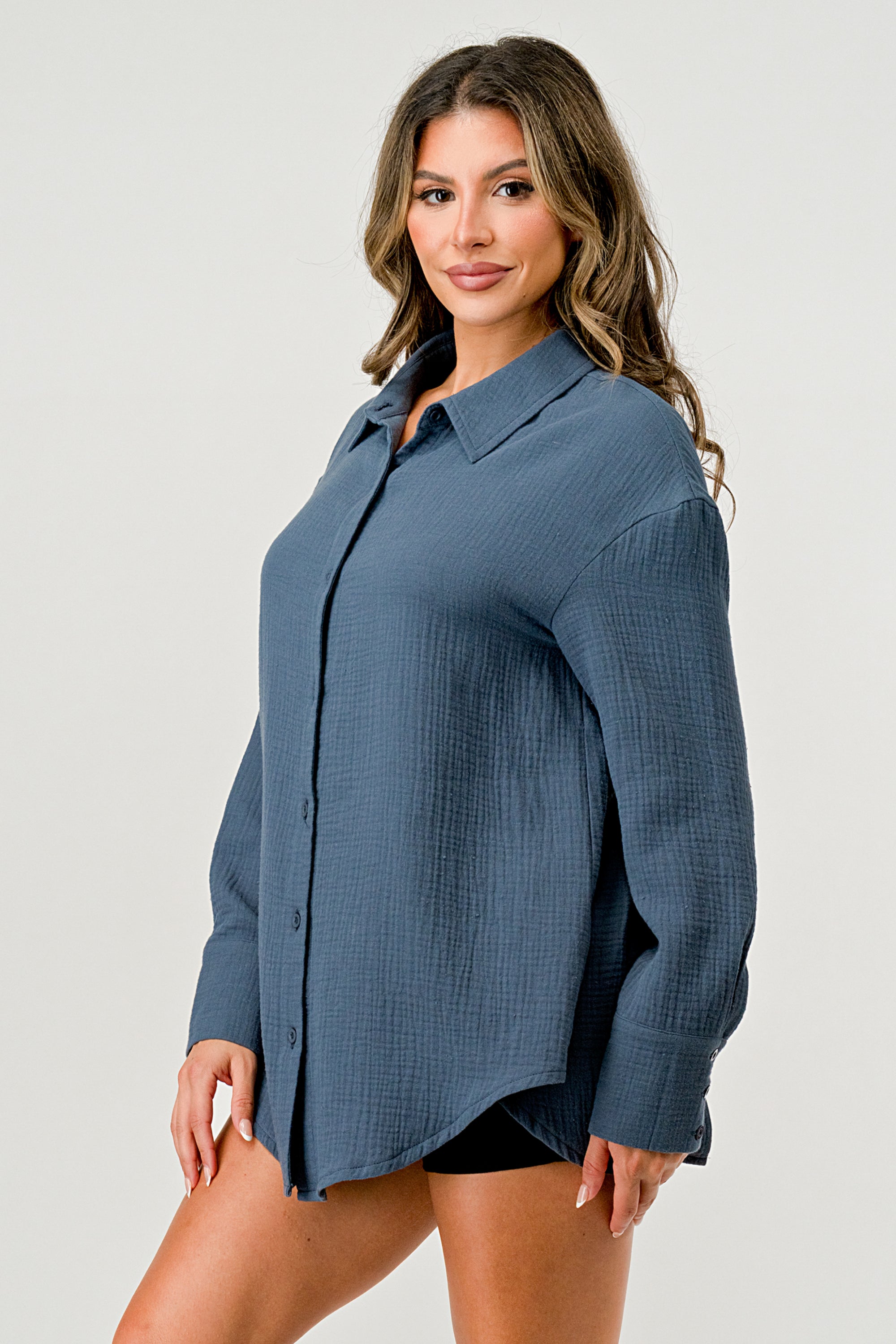 A stylish oversized button-up shirt made from soft solid gauze, featuring a button front and a slit back design for added breathability.