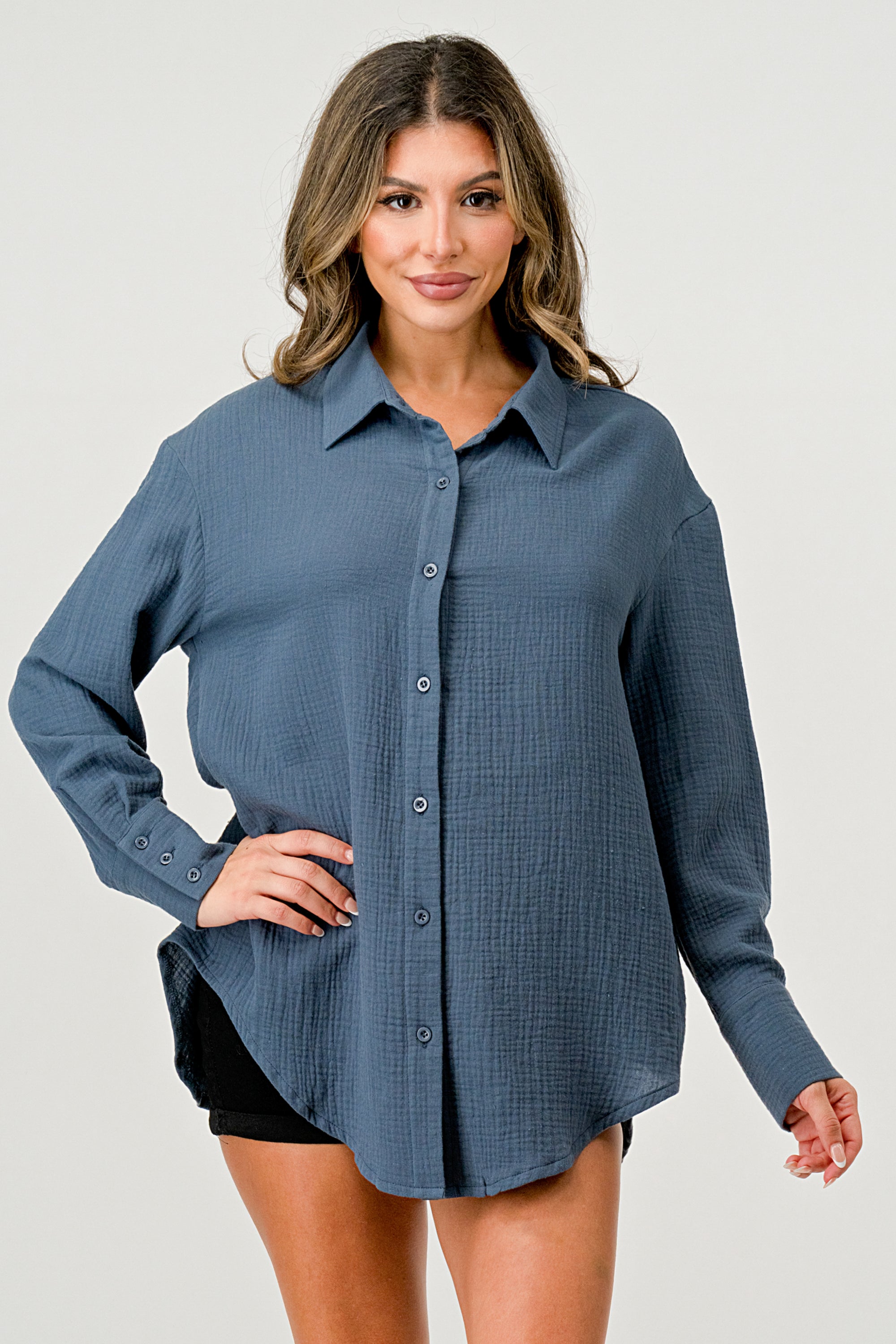 A stylish oversized button-up shirt made from soft solid gauze, featuring a button front and a slit back design for added breathability.