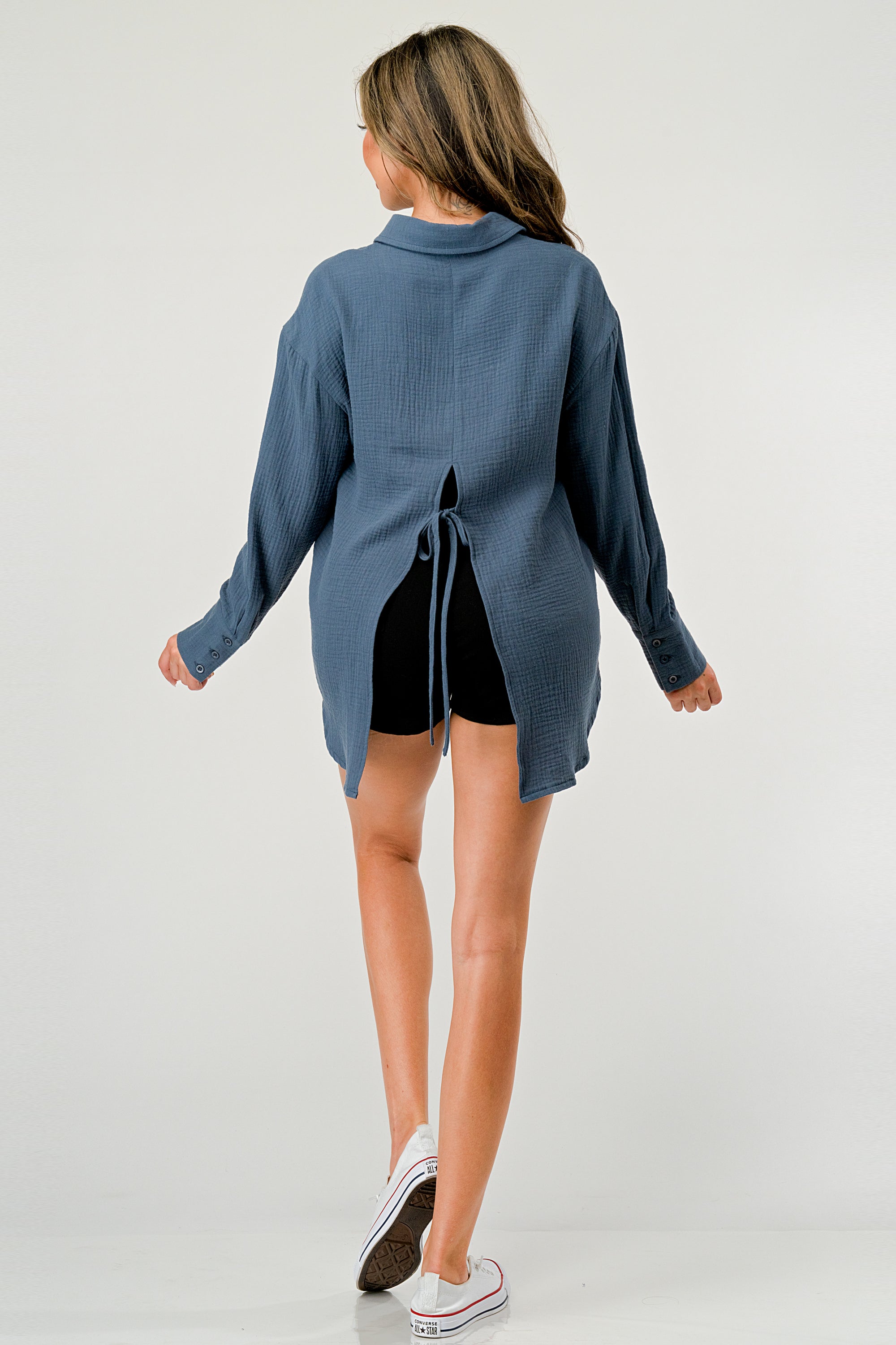 A stylish oversized button-up shirt made from soft solid gauze, featuring a button front and a slit back design for added breathability.