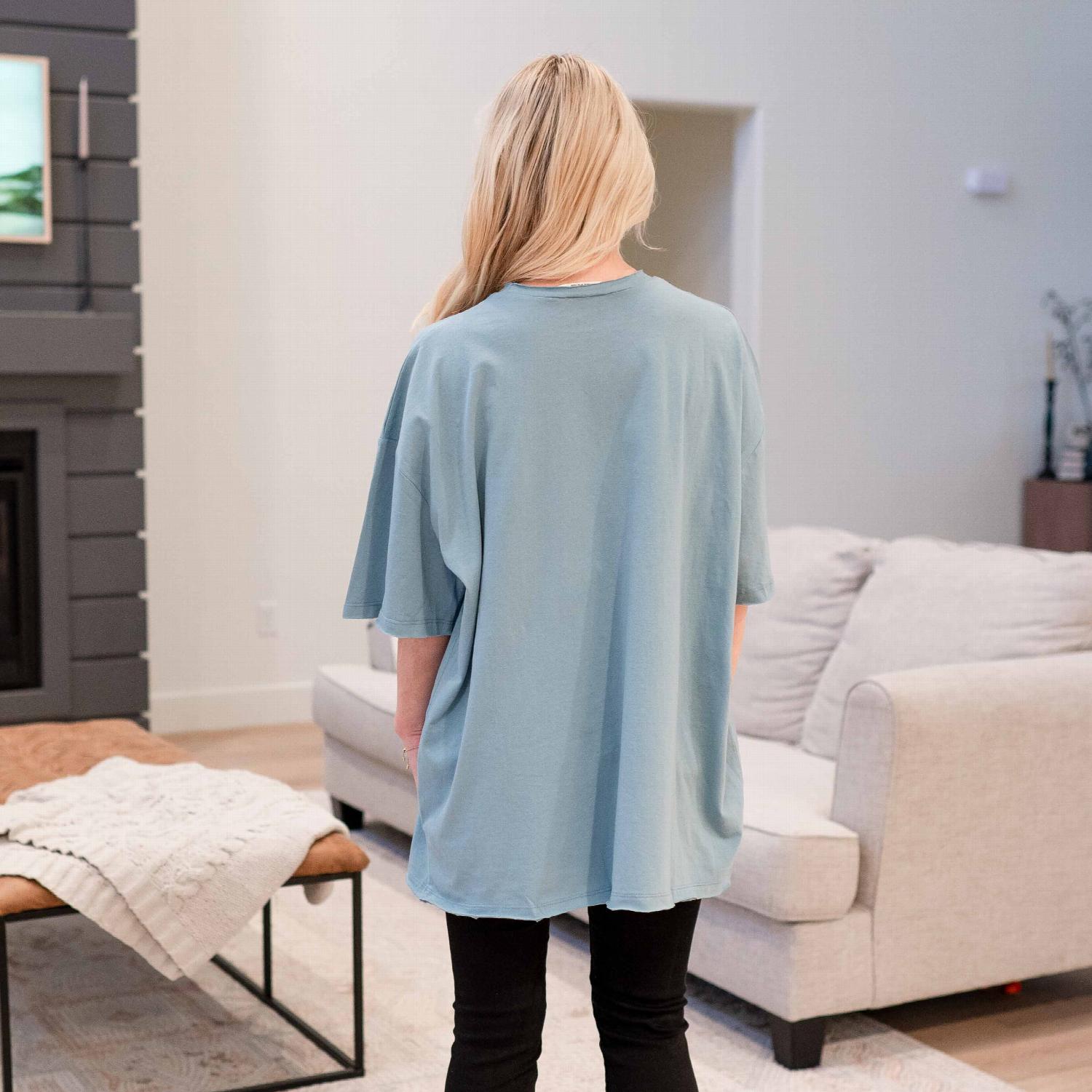 A stylish oversized boyfriend tee with a front pocket, featuring raw edge detailing, perfect for casual wear.