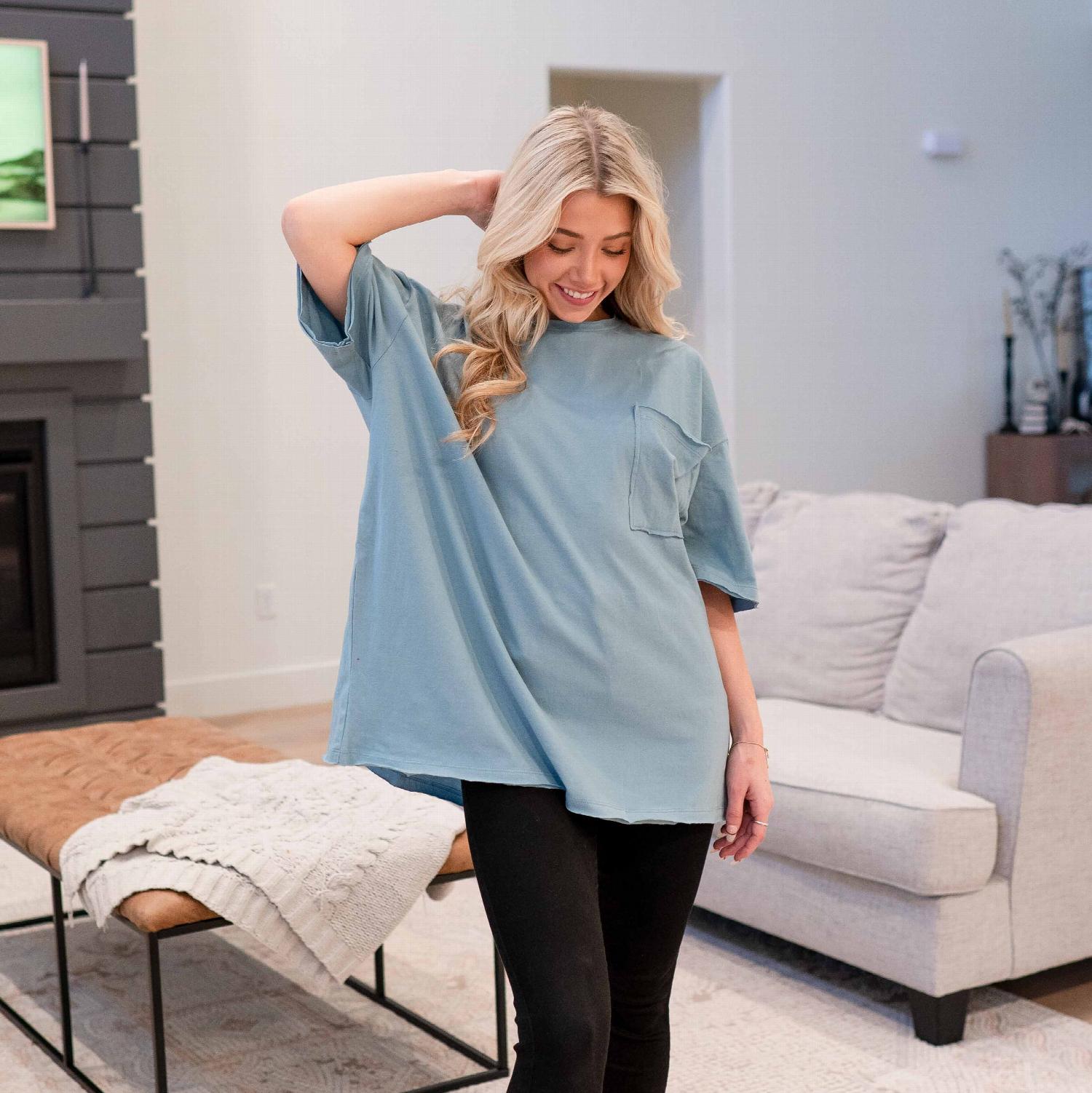 A stylish oversized boyfriend tee with a front pocket, featuring raw edge detailing, perfect for casual wear.