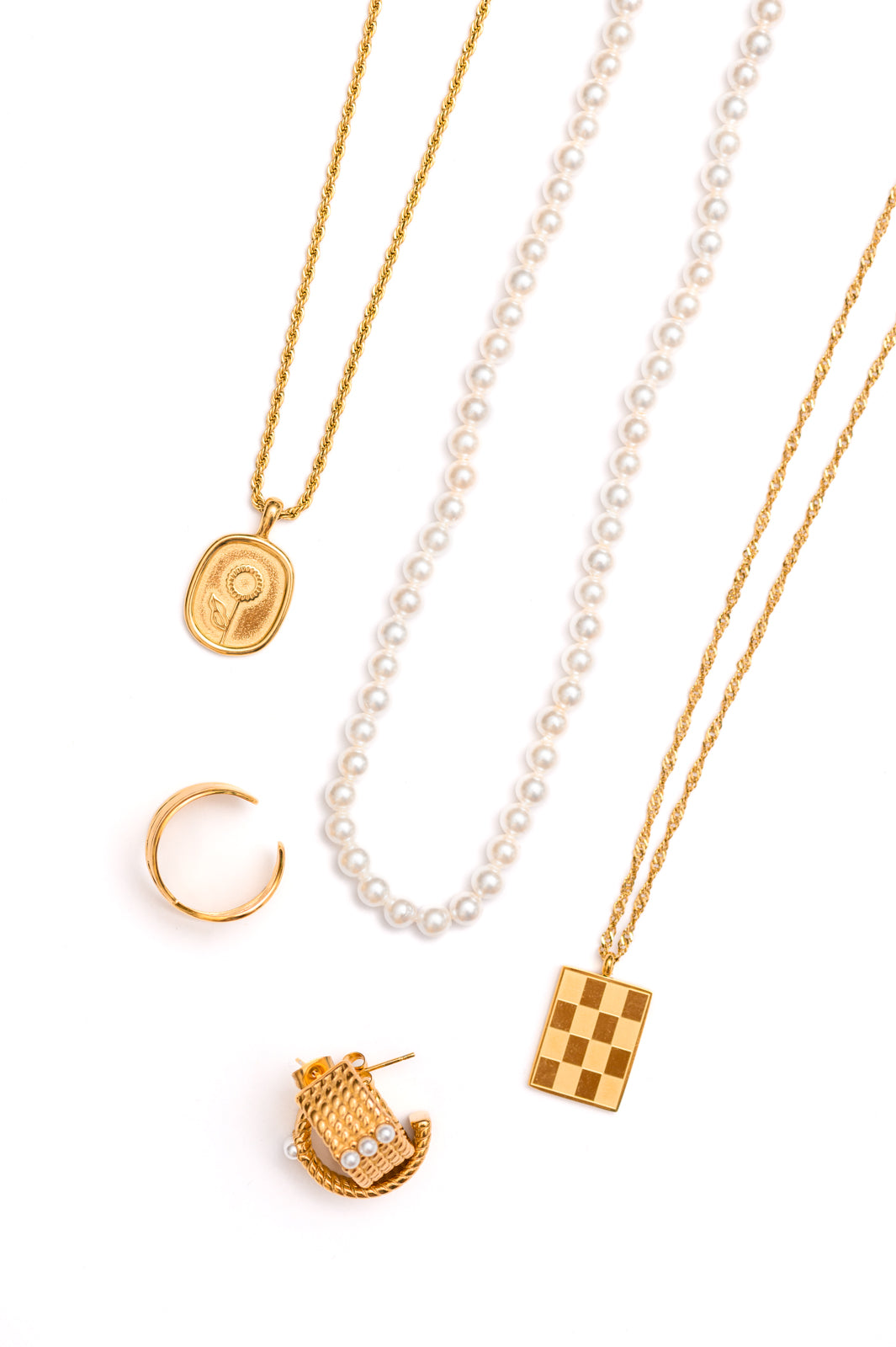 A beautiful jewelry bundle featuring a sunflower pendant necklace, checkered pendant necklace, gold ring, hoop earrings, and faux pearl necklace, elegantly displayed.