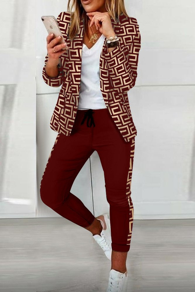Burgundy pant set featuring a stylish print blazer with geometric patterns, long sleeves, and elegant fitted pants with an elastic waist.