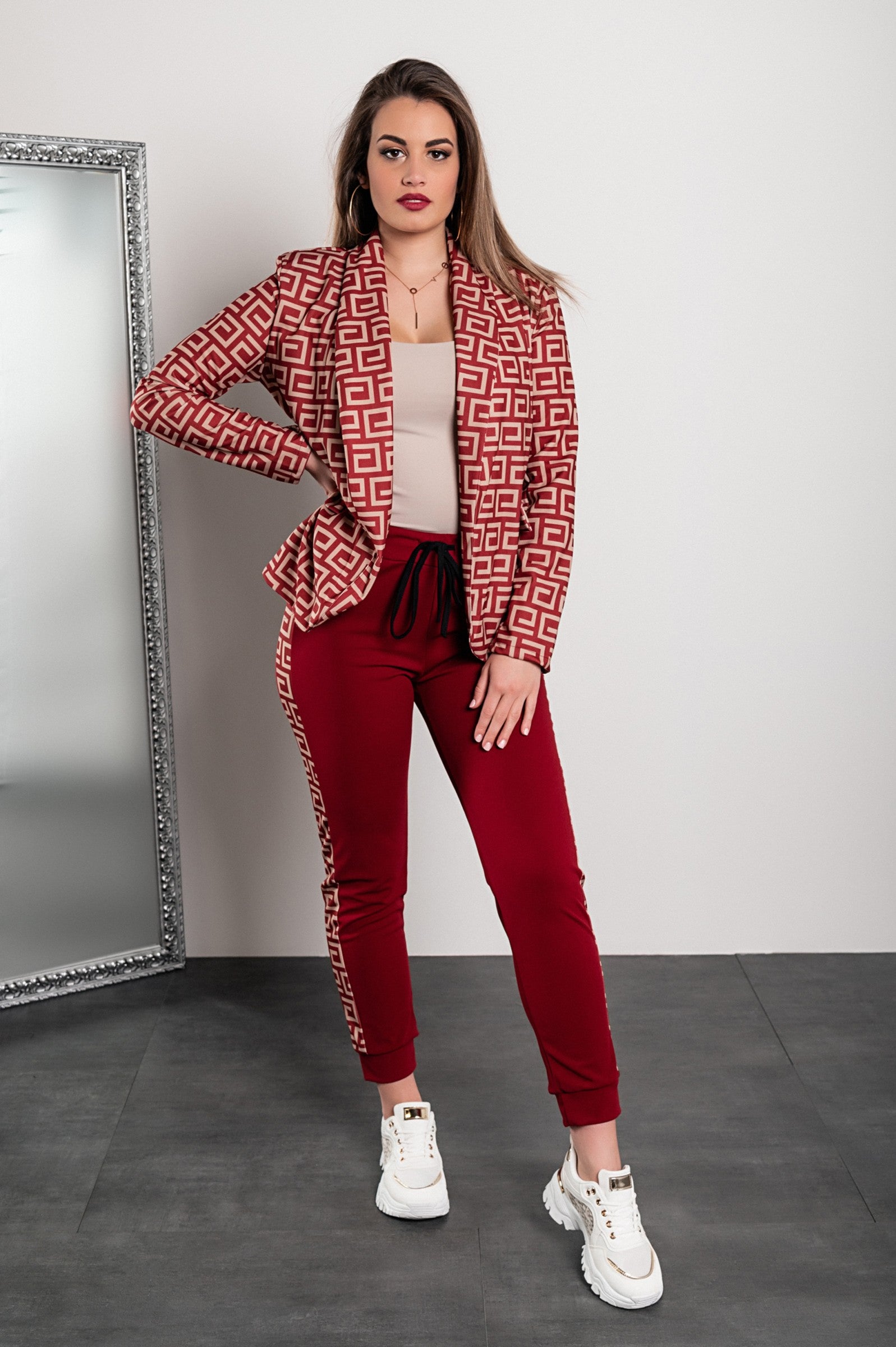 Burgundy pant set featuring a stylish print blazer with geometric patterns, long sleeves, and elegant fitted pants with an elastic waist.