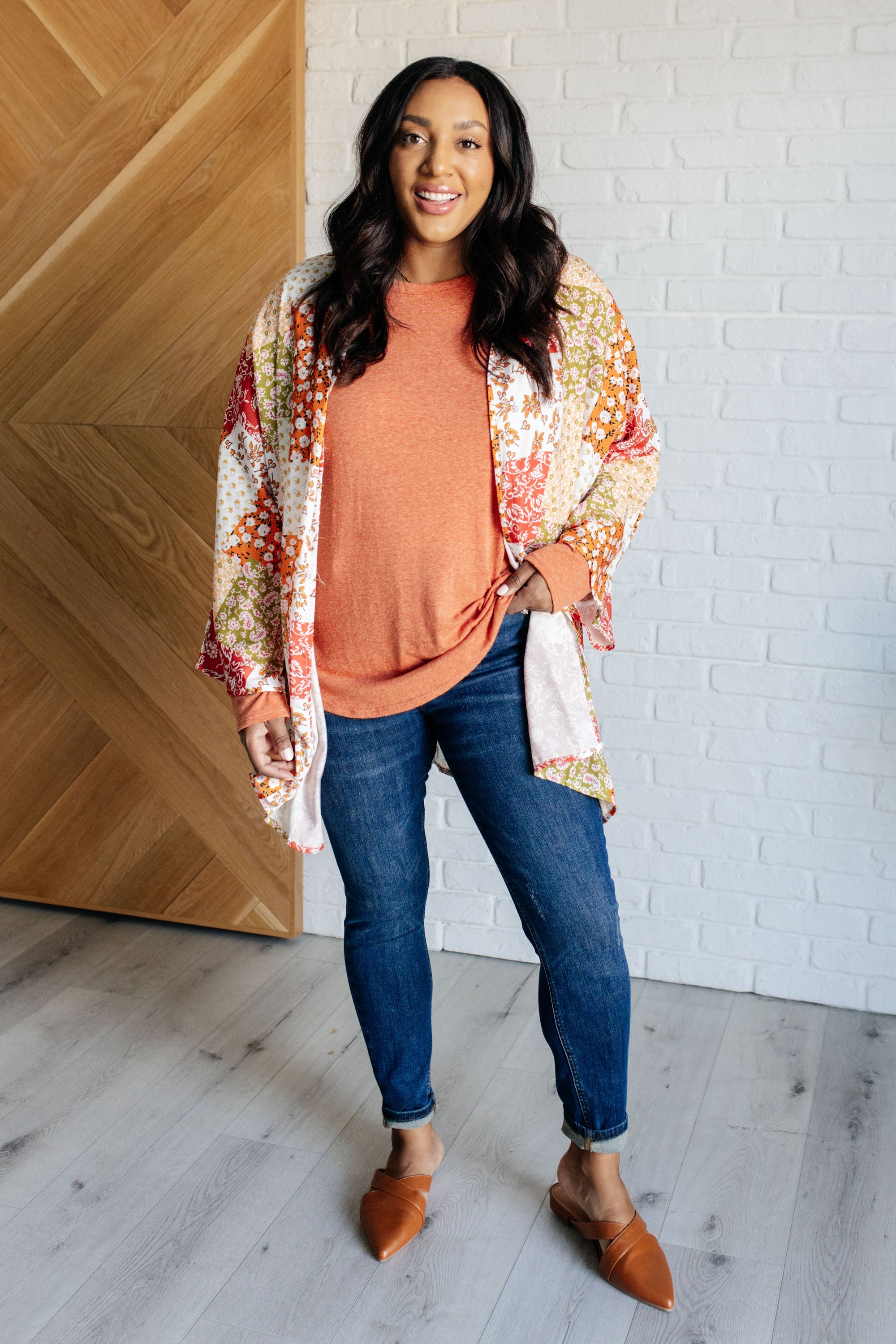 A vibrant mixed floral kimono with dolman sleeves and an open front, made from lightweight poplin fabric.