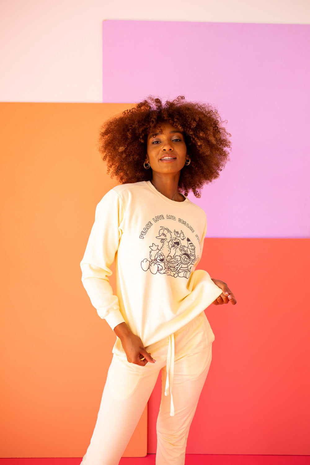 Ivory Peace Love and Sesame Sweatshirt made from 100% upcycled cotton, featuring a playful design that embodies love and peace.