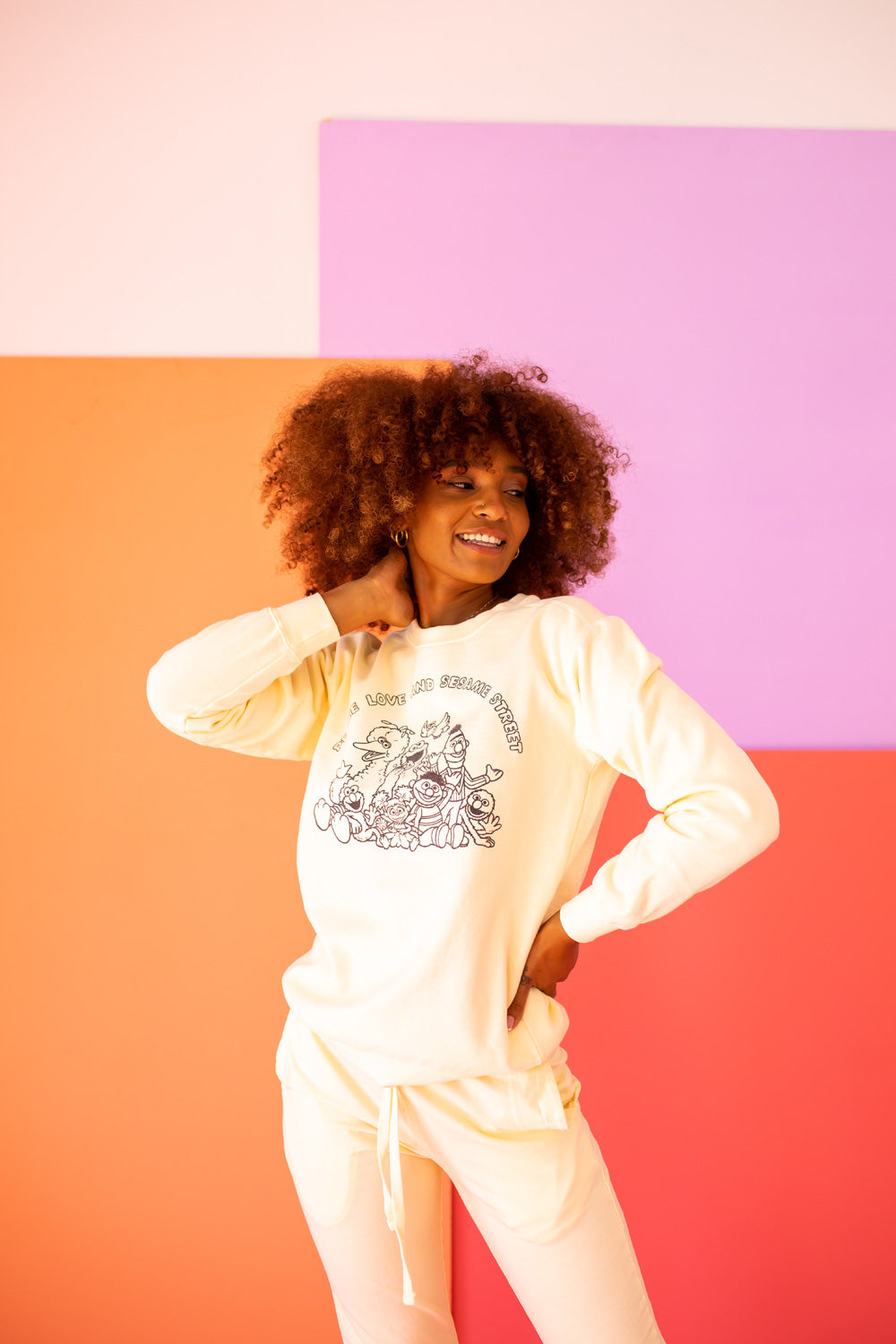 Ivory Peace Love and Sesame Sweatshirt made from 100% upcycled cotton, featuring a playful design that embodies love and peace.