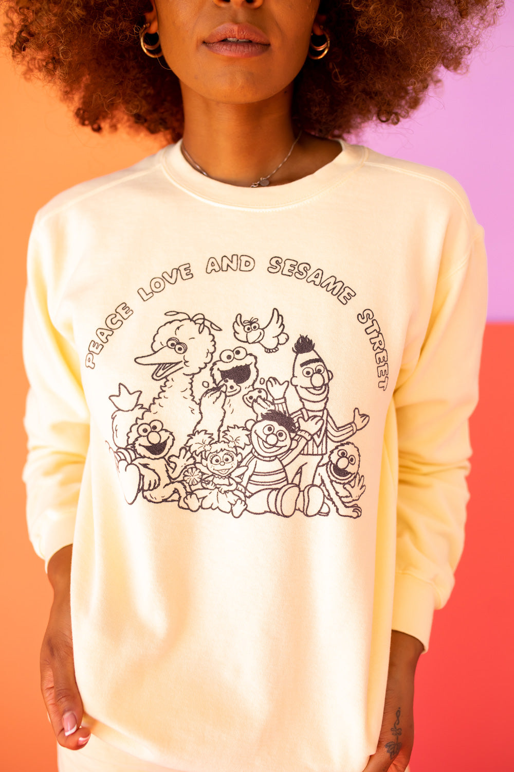 Ivory Peace Love and Sesame Sweatshirt made from 100% upcycled cotton, featuring a playful design that embodies love and peace.