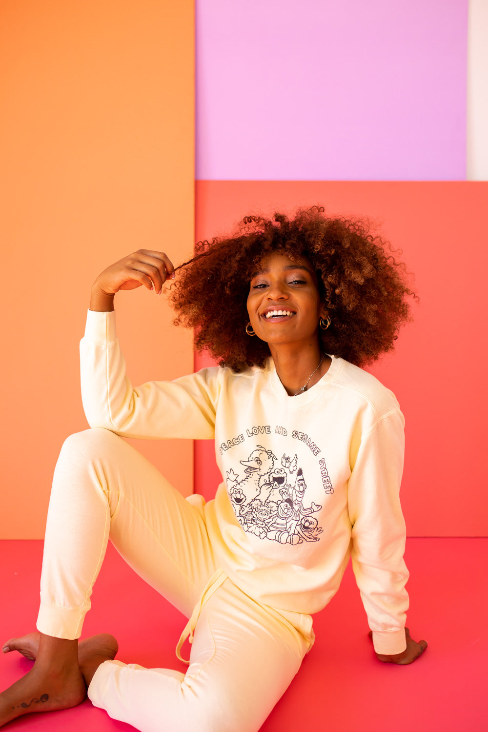 Ivory Peace Love and Sesame Sweatshirt made from 100% upcycled cotton, featuring a playful design that embodies love and peace.